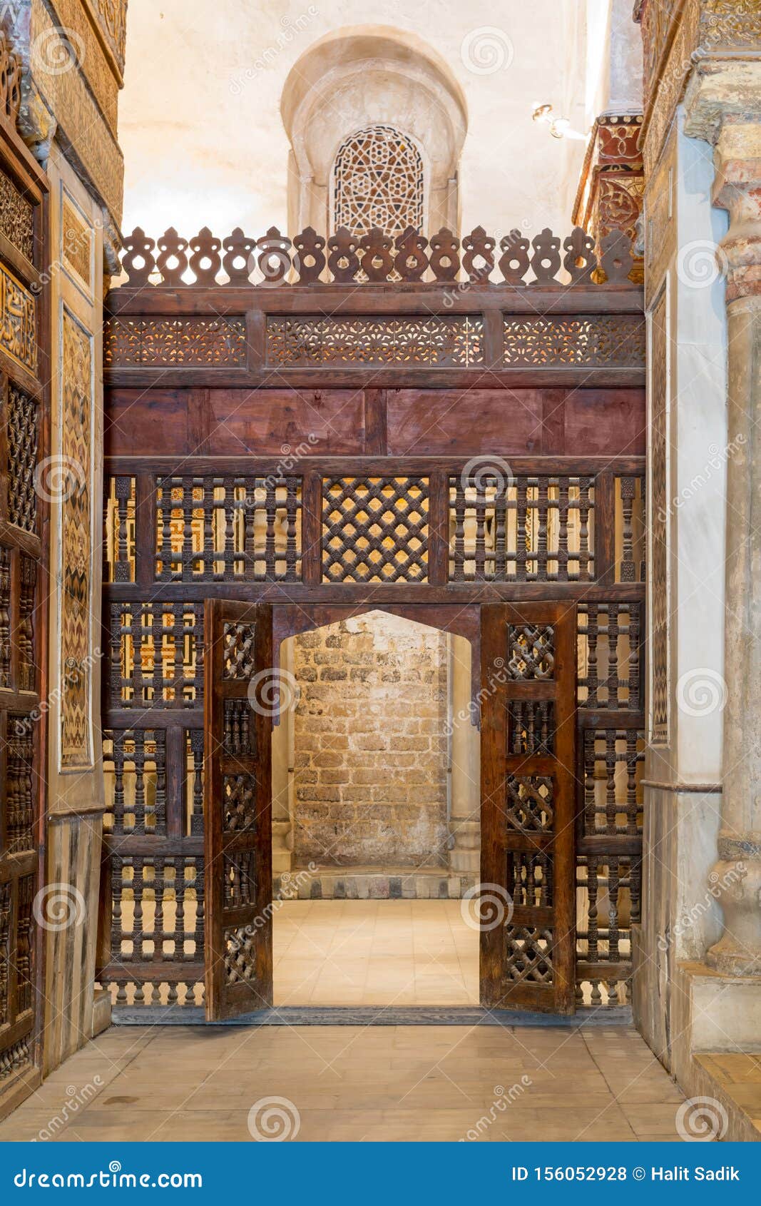 interleaved wooden wall, known as mashrabiya, with wooden ornate door