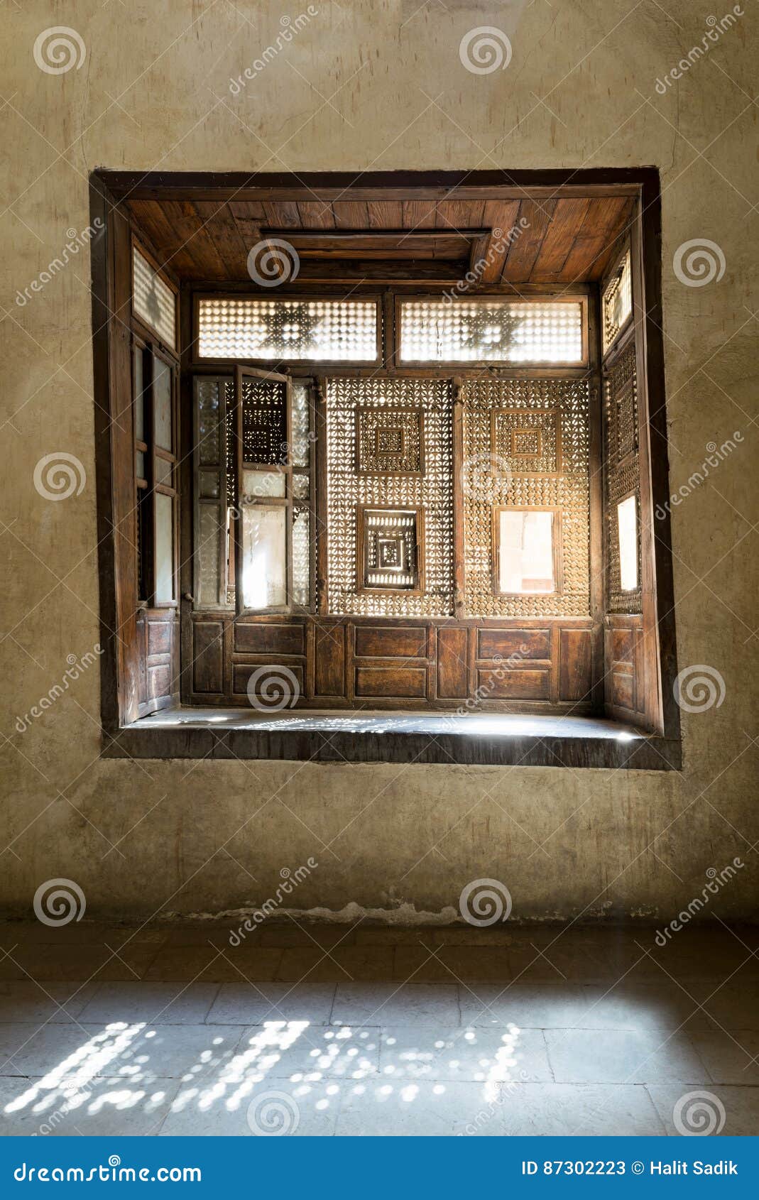 interleaved wooden window mashrabiya with built-in couch