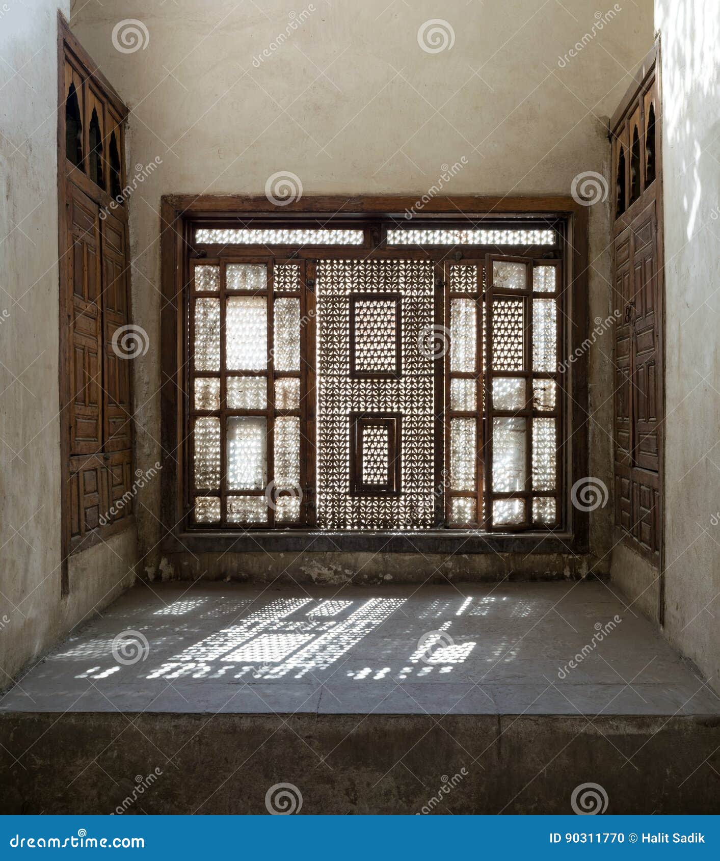 interleaved wooden window mashrabiya with built-in couch