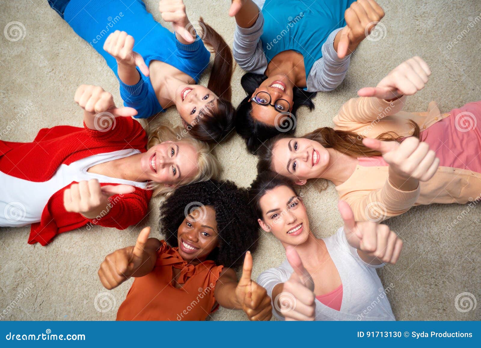 international group of women showing thumbs up