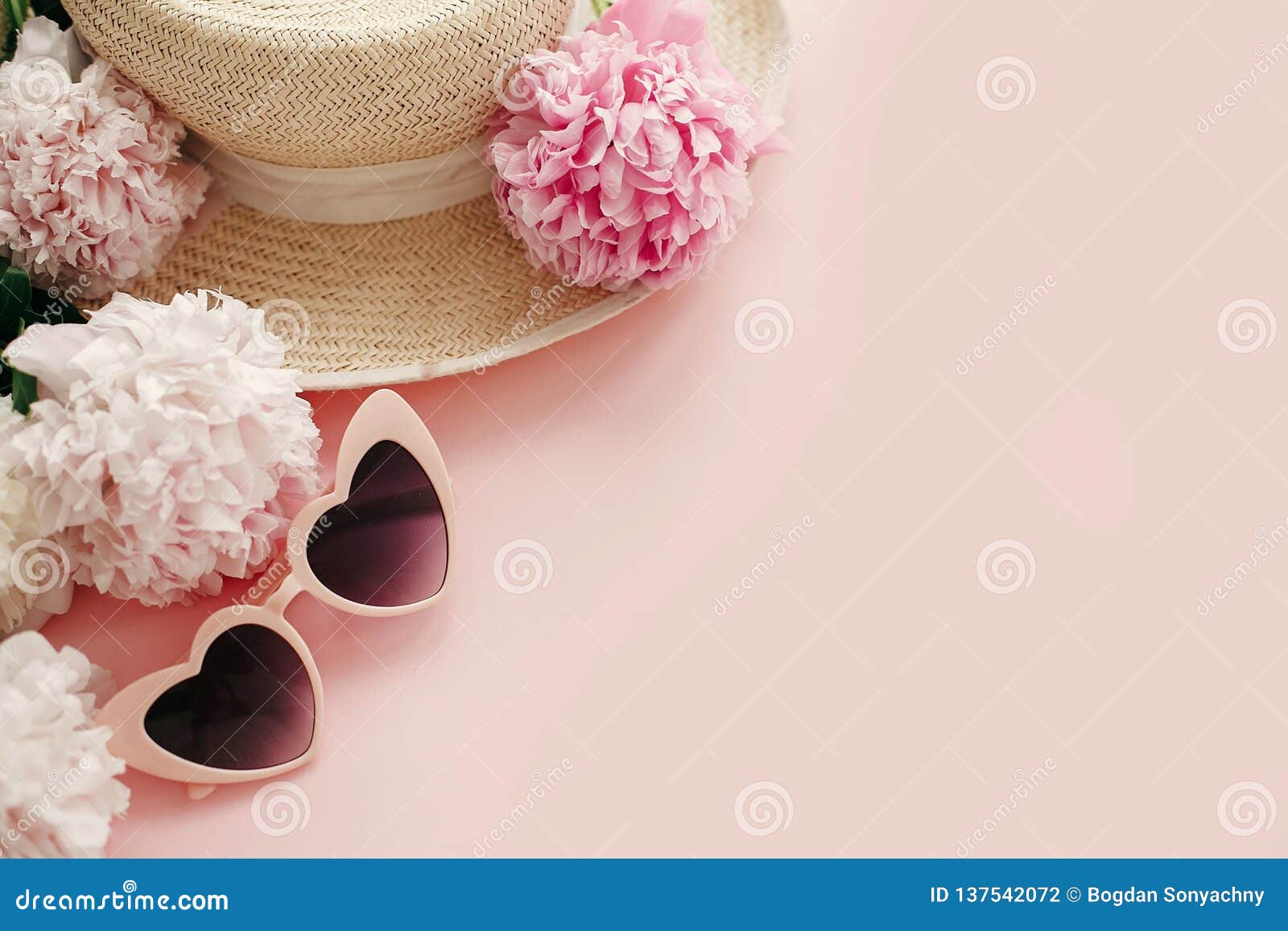 international women`s day. stylish girly pink retro sunglasses, white and pink peonies, straw hat on pastel pink paper with copy