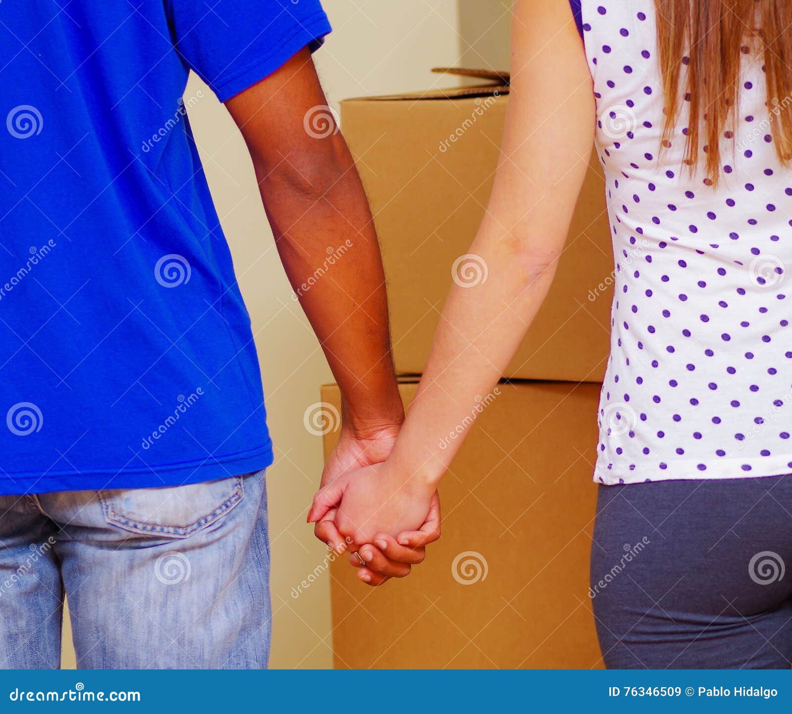 Interracial Couple Holding Hands, Seen from Behind with Stacked Boxes in  Background, Moving in Concept Stock Image - Image of coffee, adult: 76346509