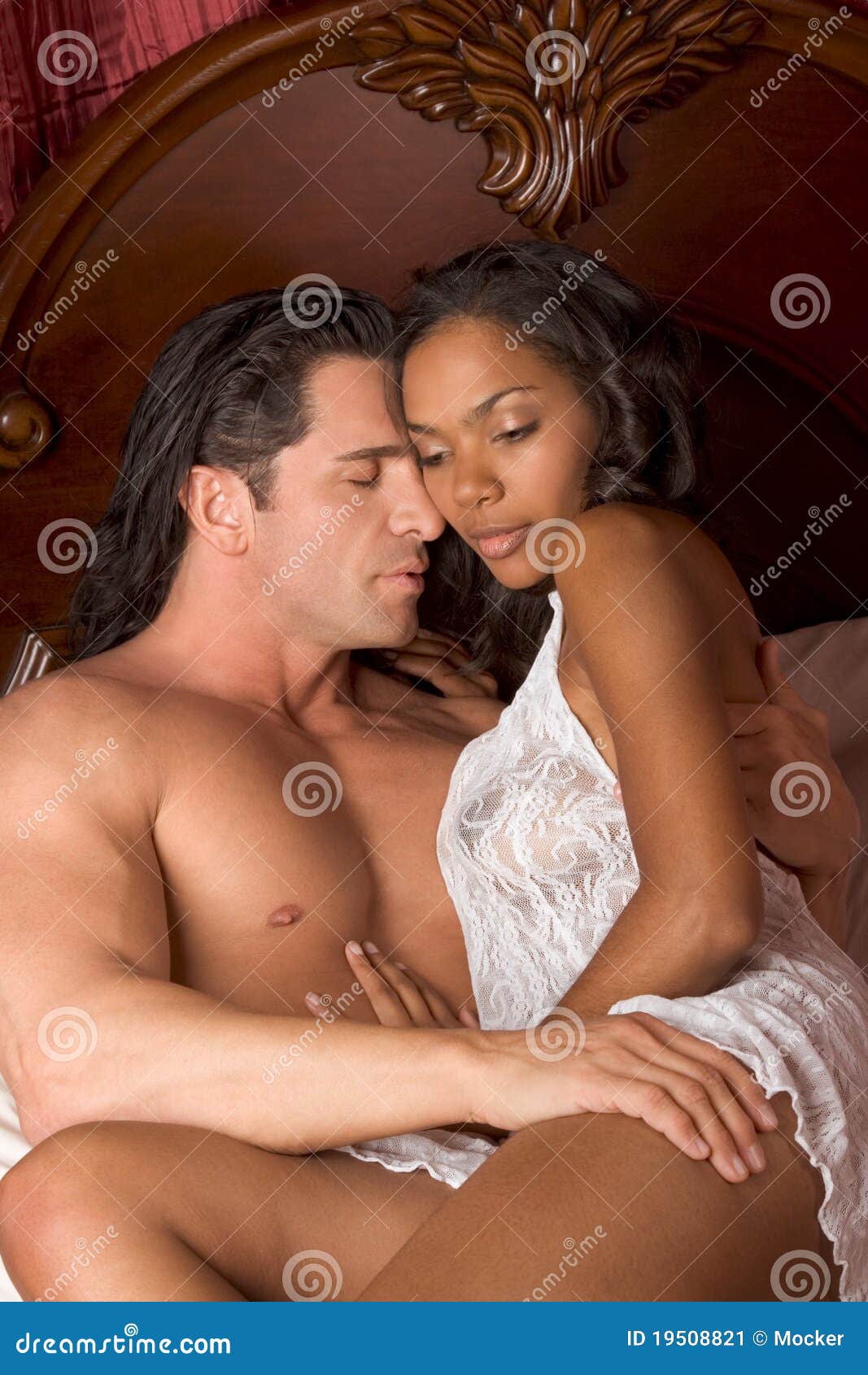 Interracial Heterosexual Sensual Couple in Bed Stock Image photo