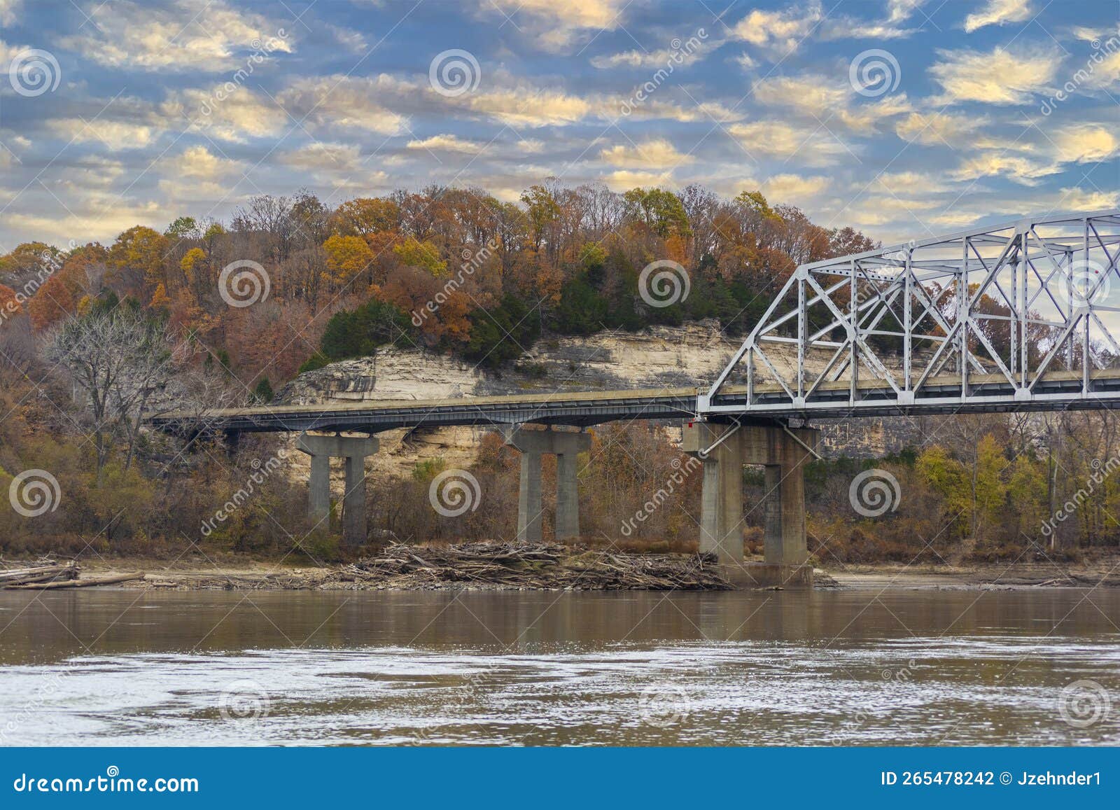 interstate 70 highway truss bridge over the missouri river with bluffs and colorful fall autumn leaves