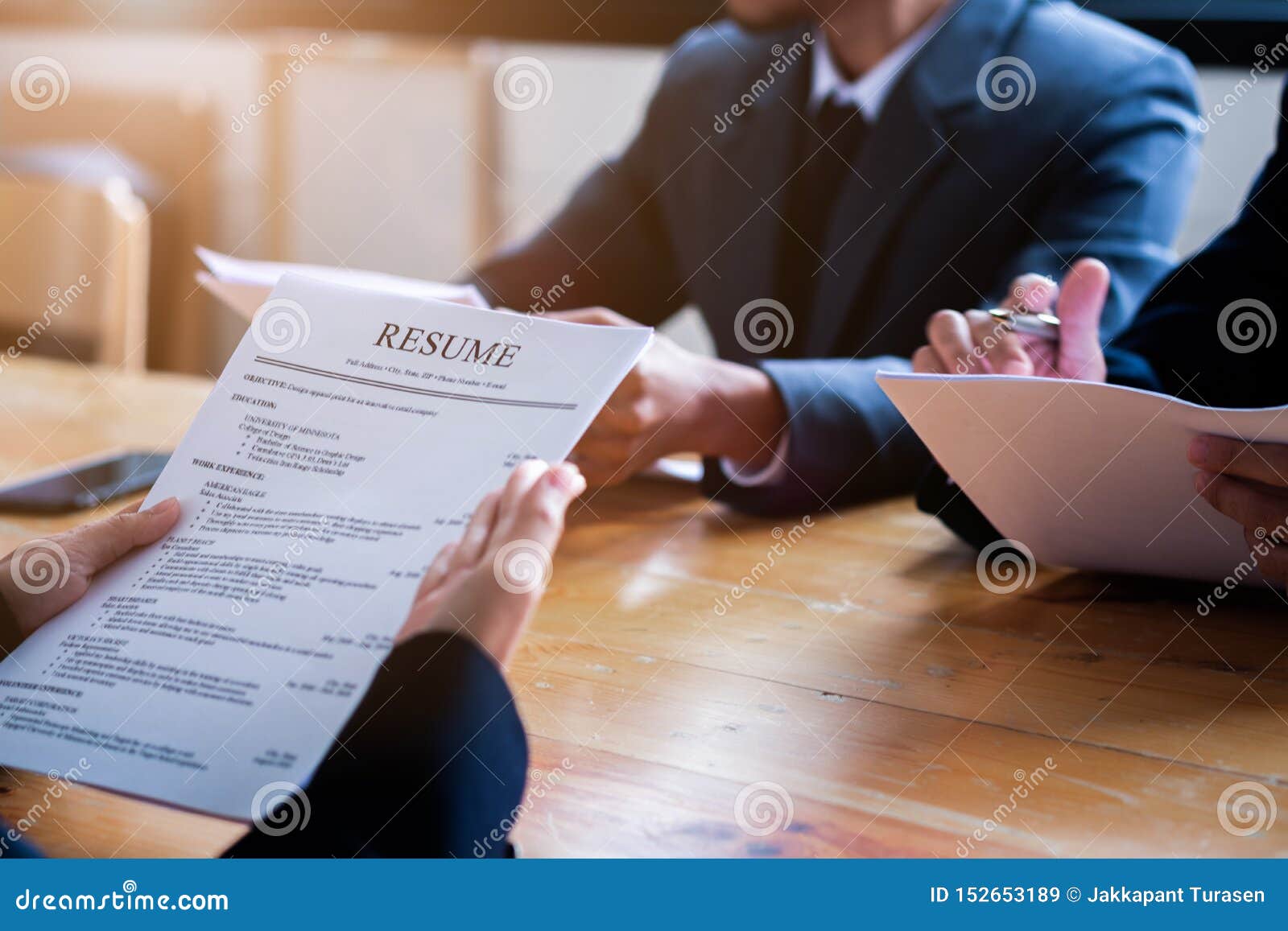 interviewer reading a resume, person submits job application, person describe yourself to interviewer, close up view of job