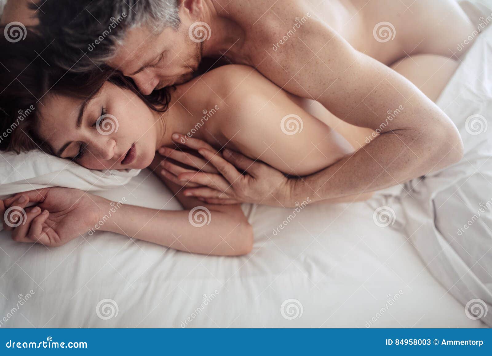 Intimate Couple Making Love in Bed Stock Image