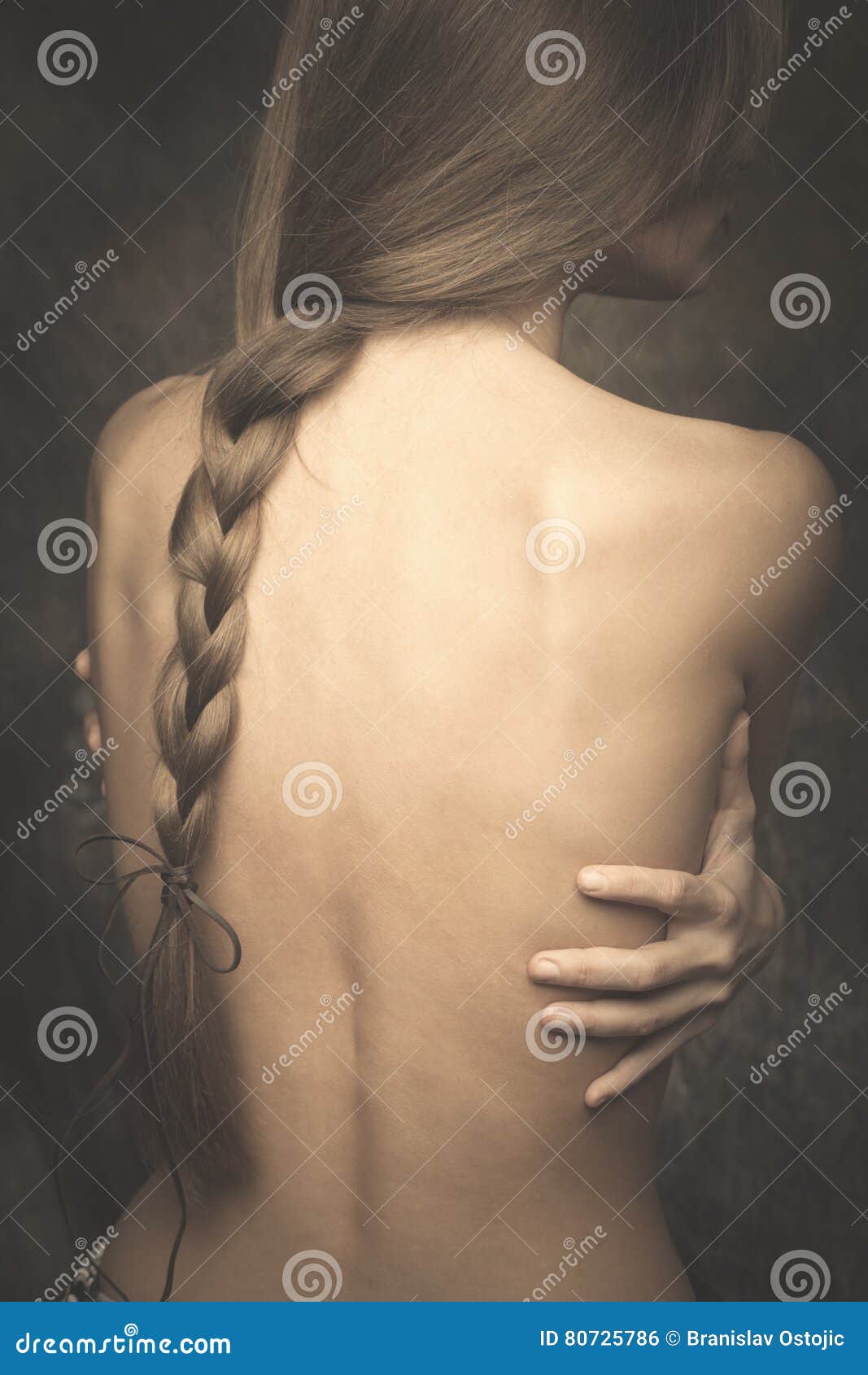 intimate woman portrait bare back and long braid