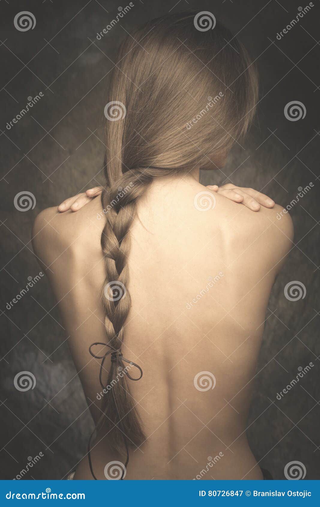 intimate woman portrait bare back and long braid