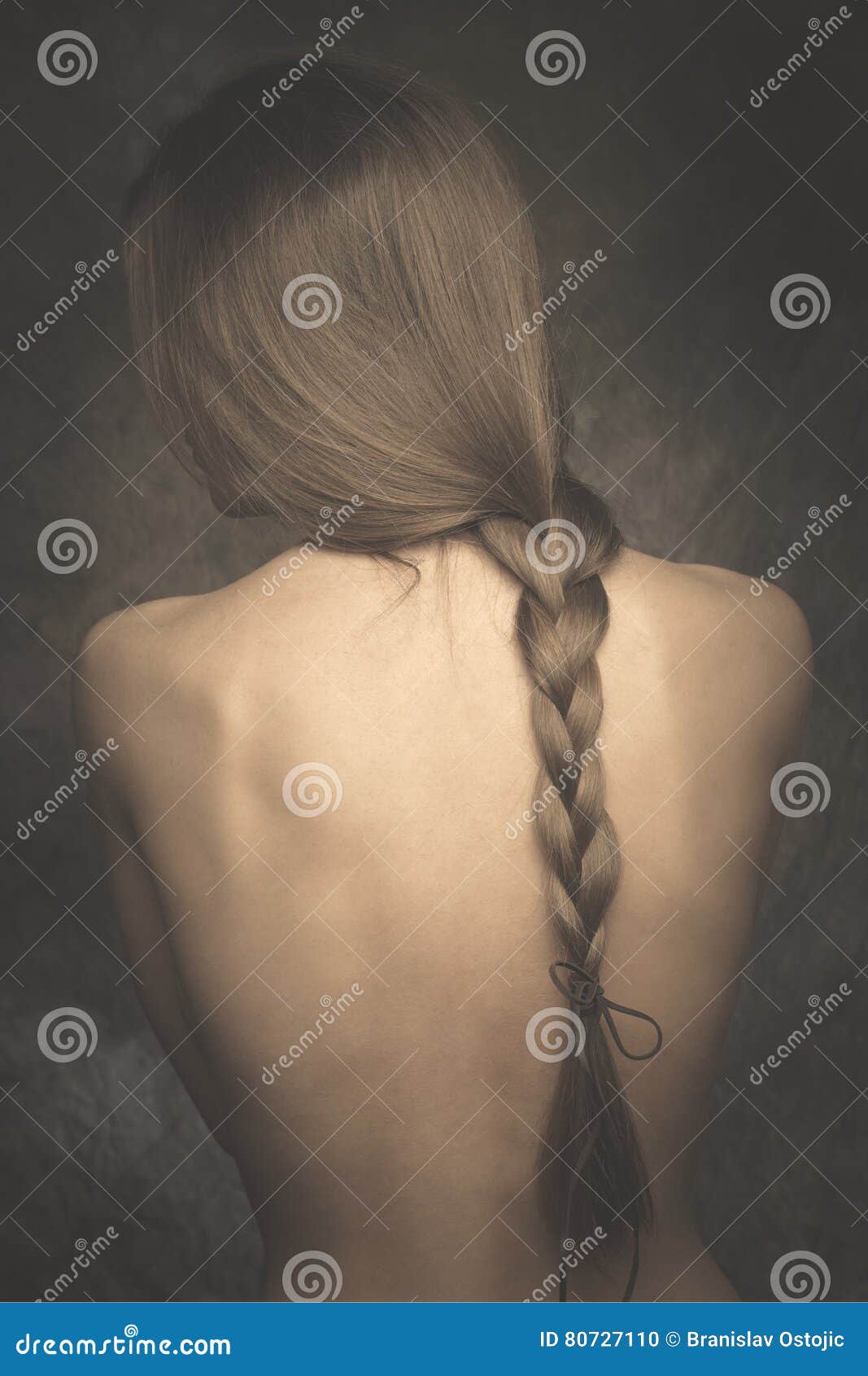 intimate woman portrait bare back and long braid