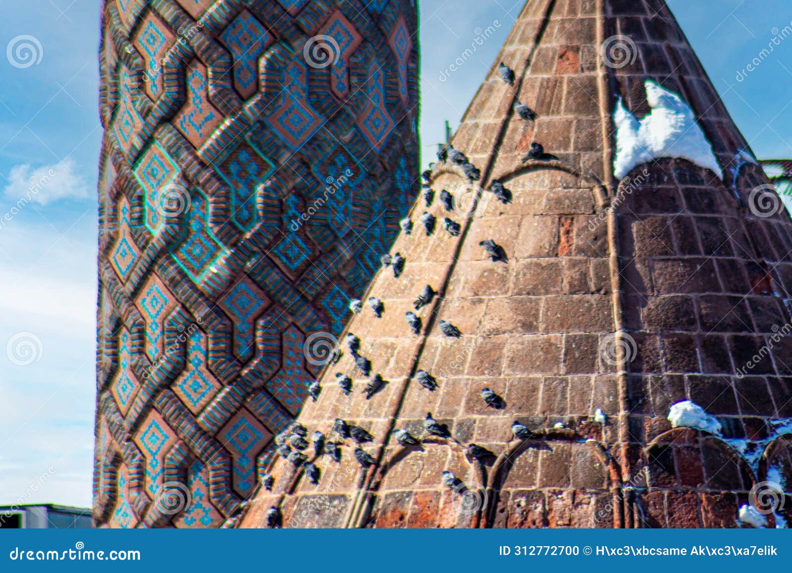 intricate patterns on yakutiye madrasa minarets in erzurum, adorned with perched pigeons under clear skies.