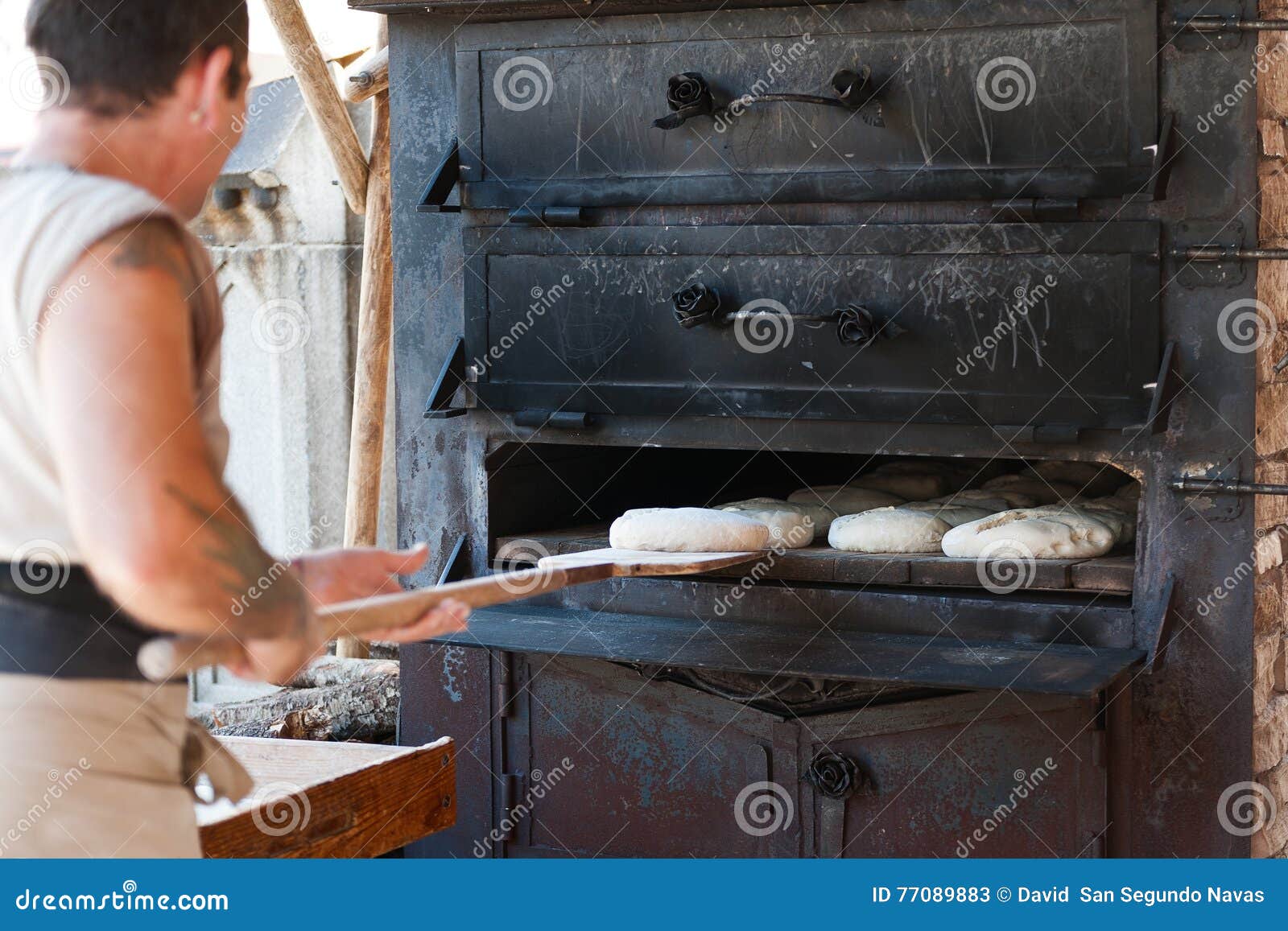 Introducing Artisan Baker Dough in the Oven Editorial Stock Photo