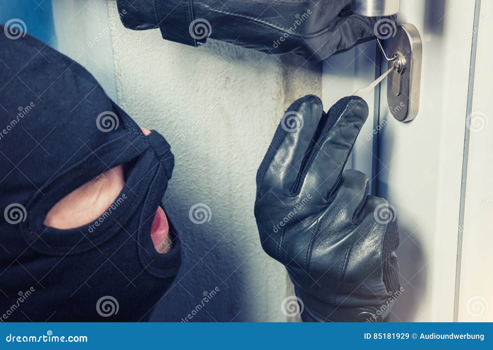 intruder or burglar with lock picking tools