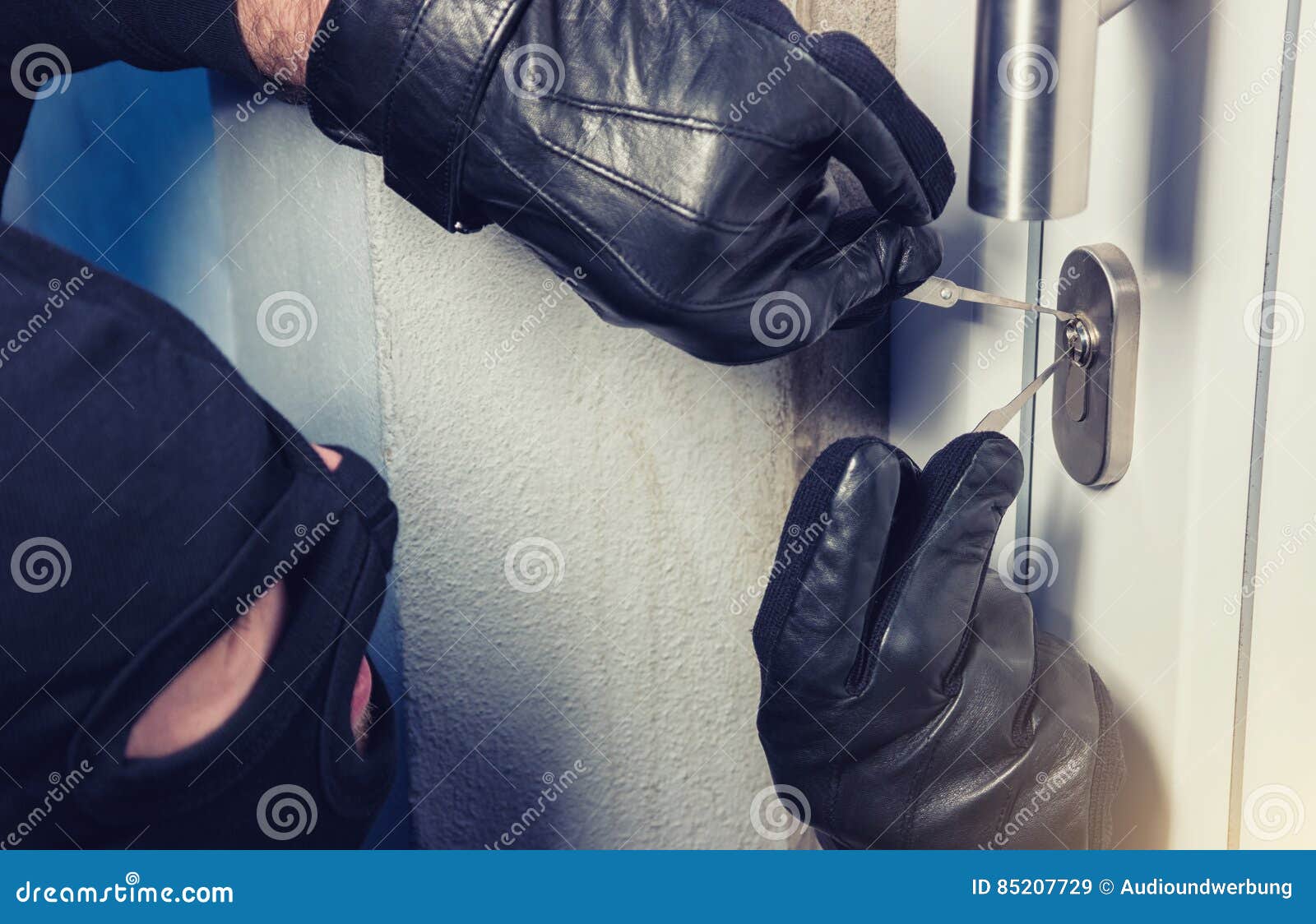 intruder or burglar with lock picking tools