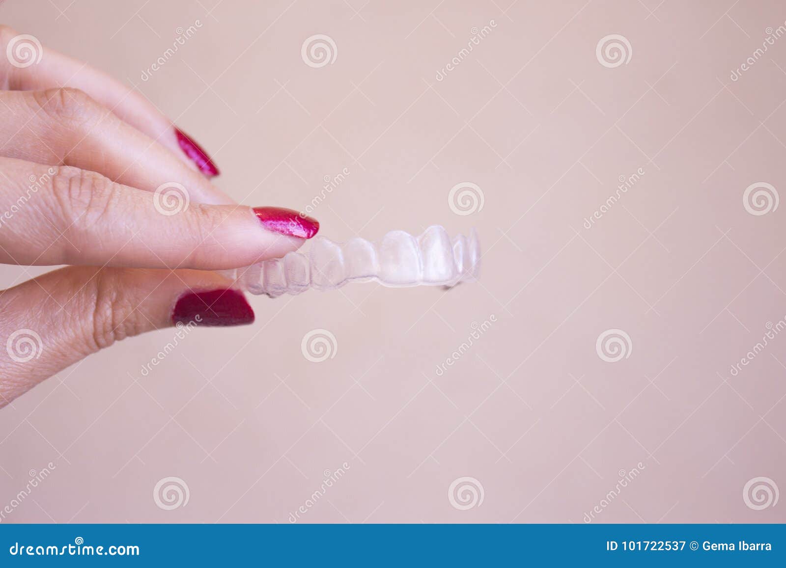 invisible dental orthodontics held by a woman