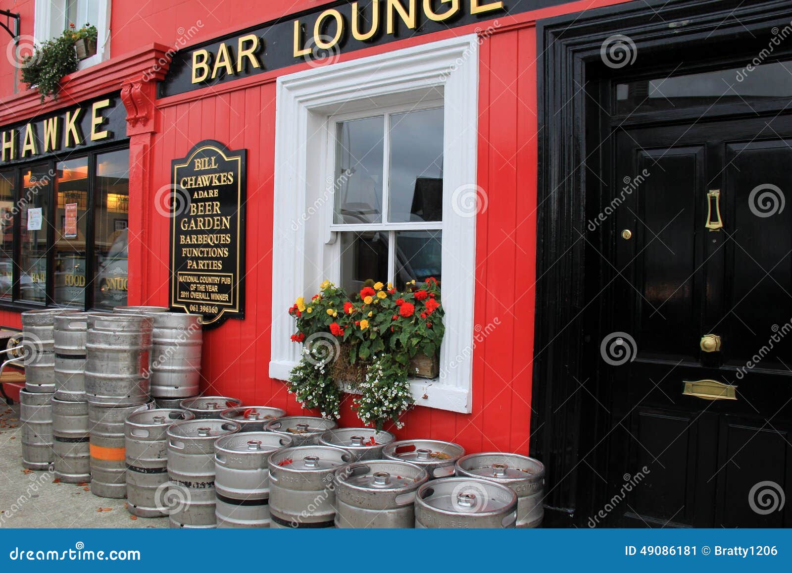 Inviting Scene Of Colorful Kegs And Flowers In Window Boxes