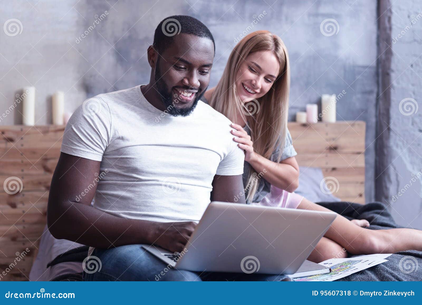 https://thumbs.dreamstime.com/z/involved-international-couple-enjoying-online-shopping-home-testing-peaceful-smiling-sitting-bedroom-using-gadget-95607318.jpg