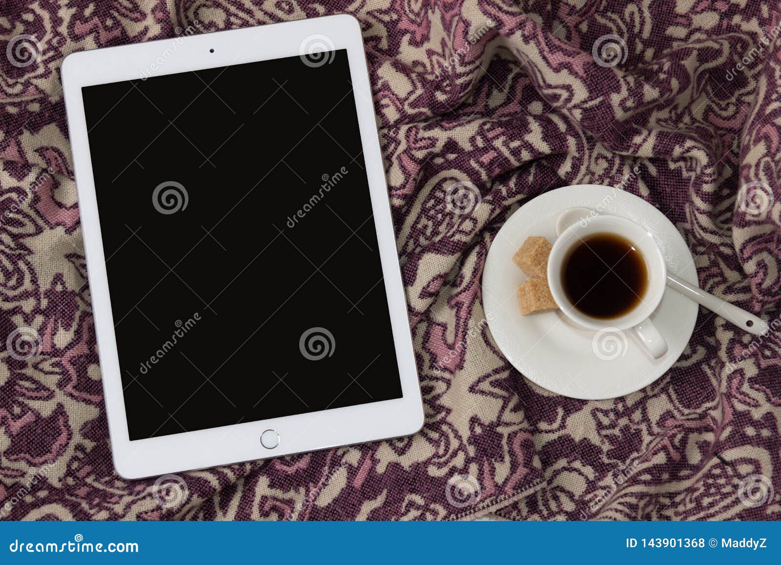 ipad apple tablet with a cup of coffee. elegant and cozy feminine background, concept for advertisement