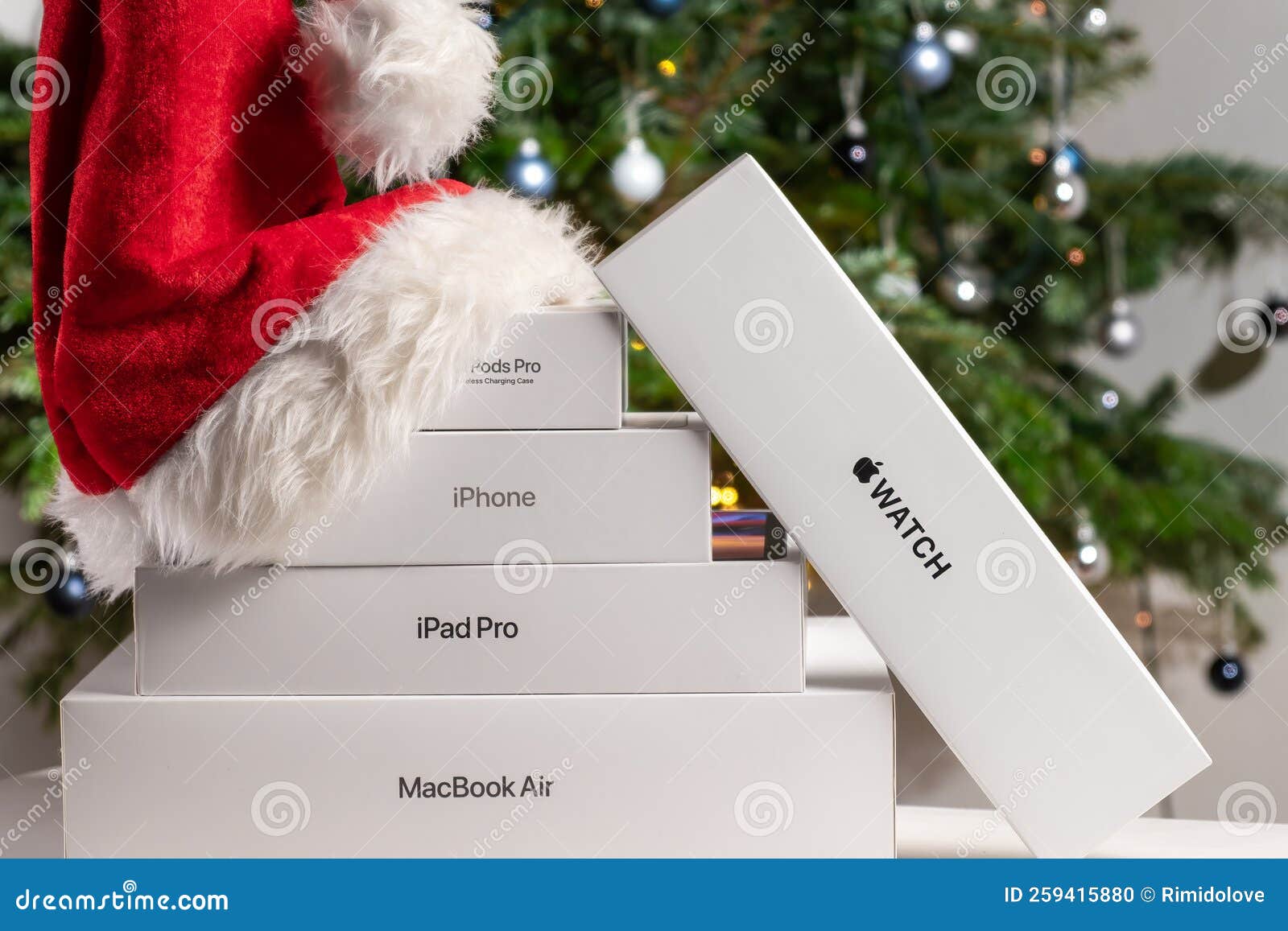 Iphone, Airpods Pro, Watch, IPad Pro Boxes with Santa Claus Hat and  Christmas Tree on the Background Editorial Image - Image of logo, gift:  259415880
