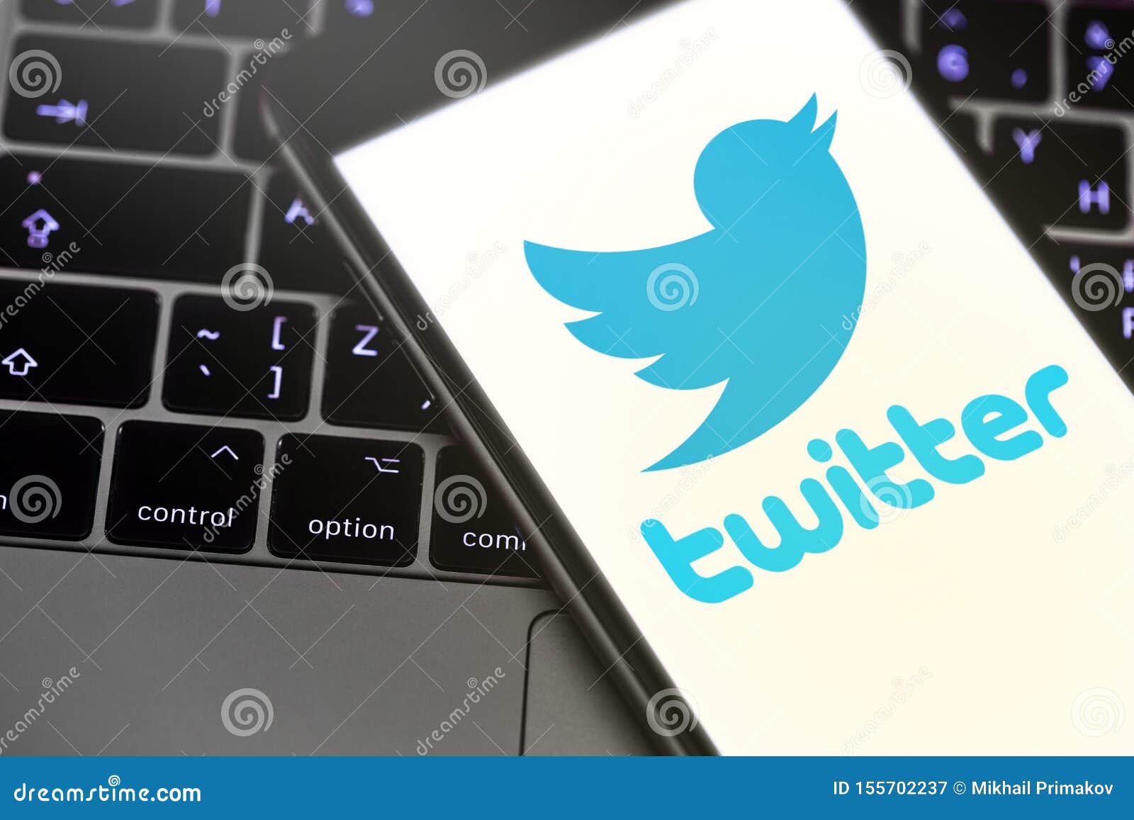 Twitter logo on the screen editorial photography. Image of logotype