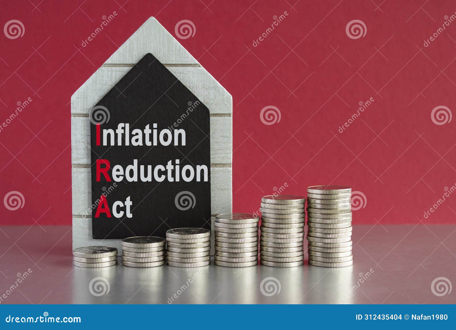 ira inflation reduction act . concept words inflation reduction act on a black board. silver coins arranged in a graph in