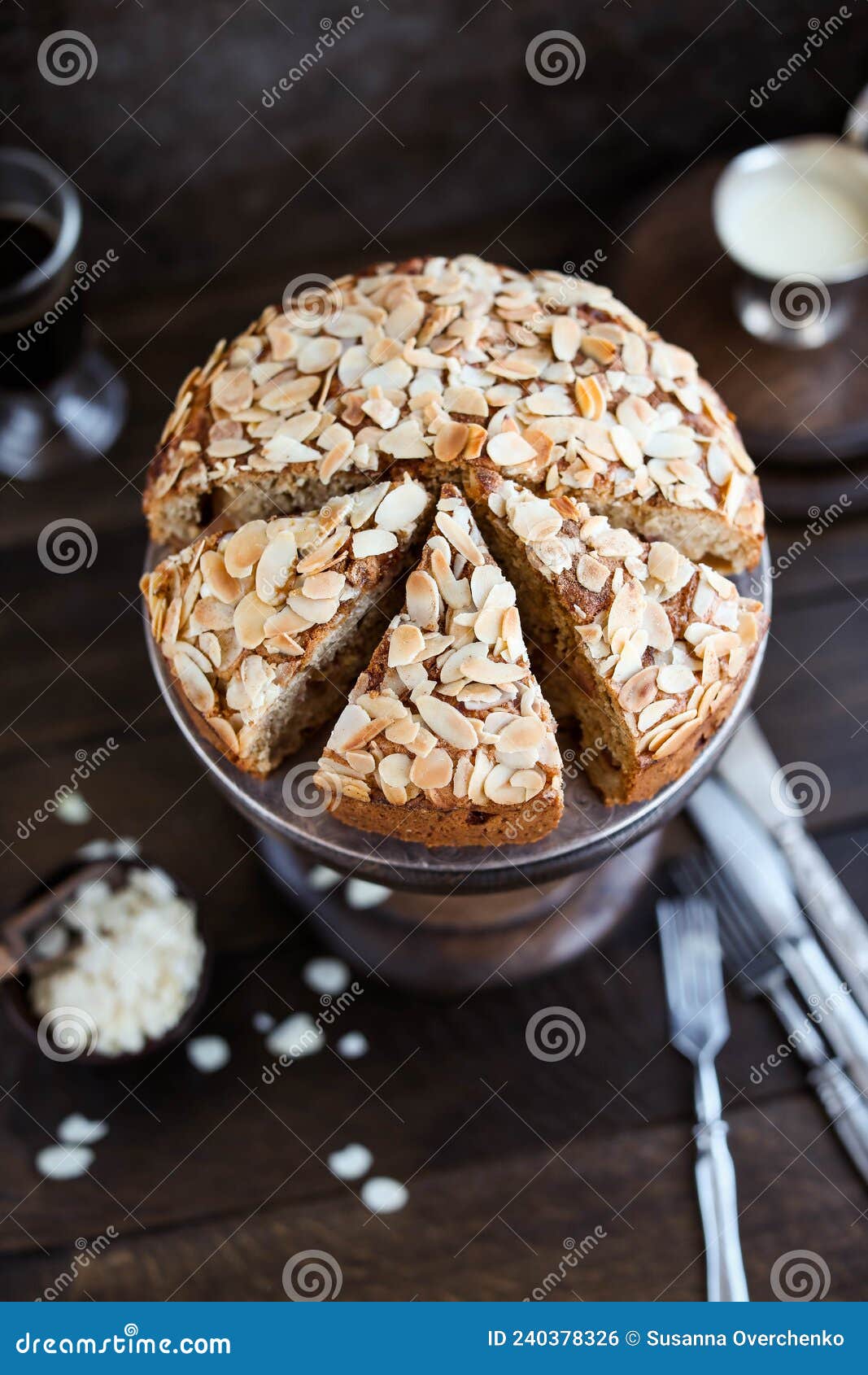 irish apple pie with almond flakes on a wooden stand.