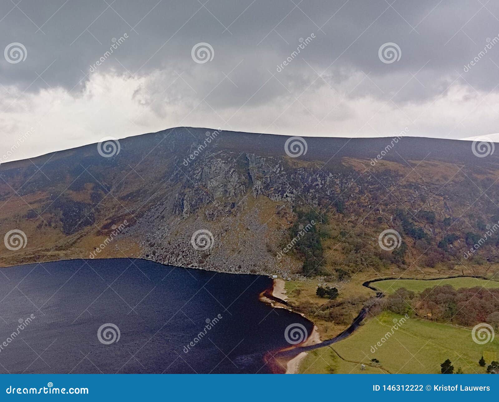 dark clouds over guiness lake in wicklow mountains