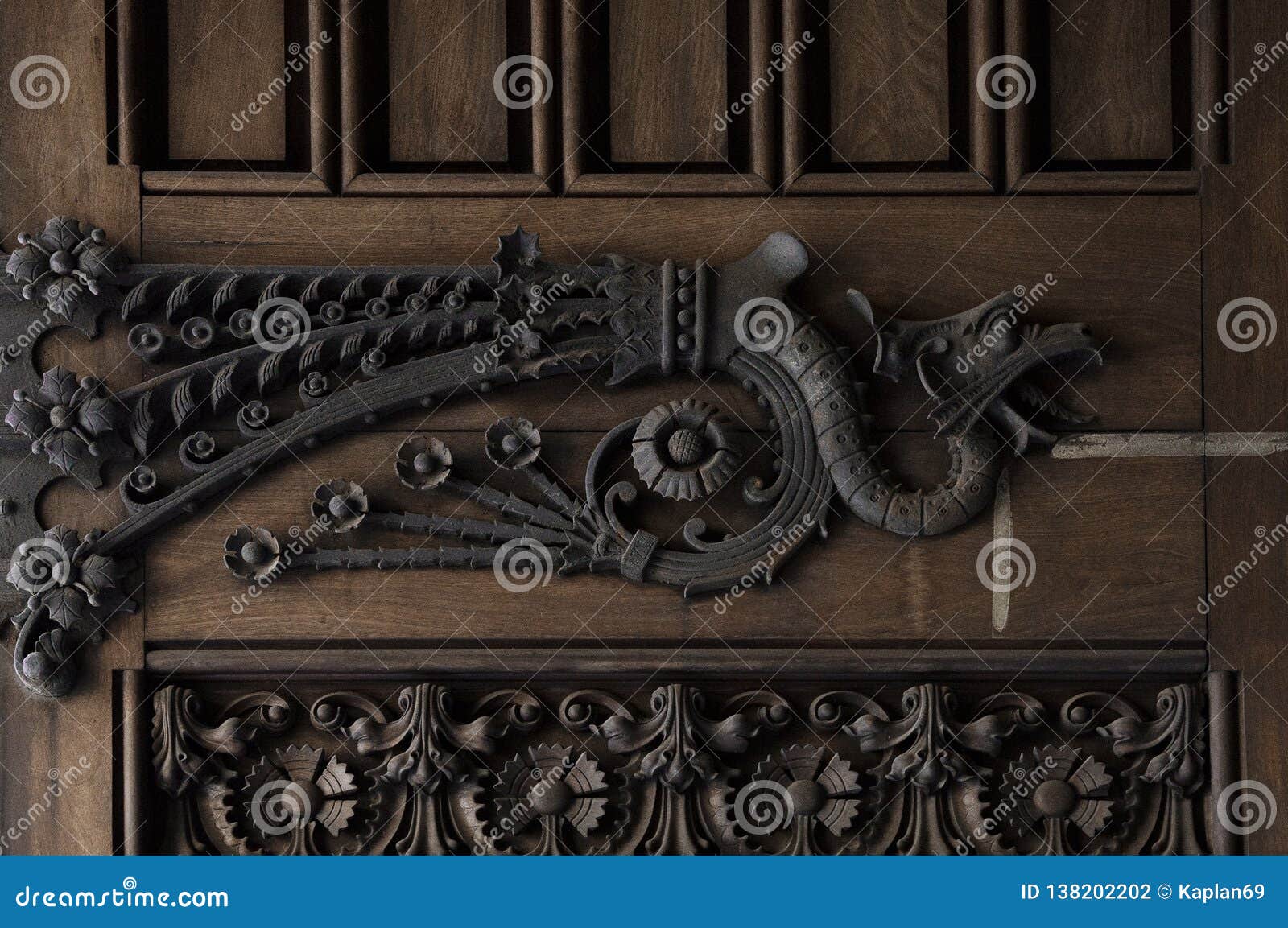 iron dragon on the main wood door