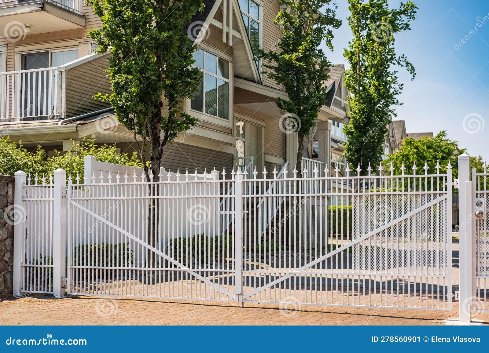 Iron Front Gate of a House. Wrought Iron White Gate and Brick Pillar