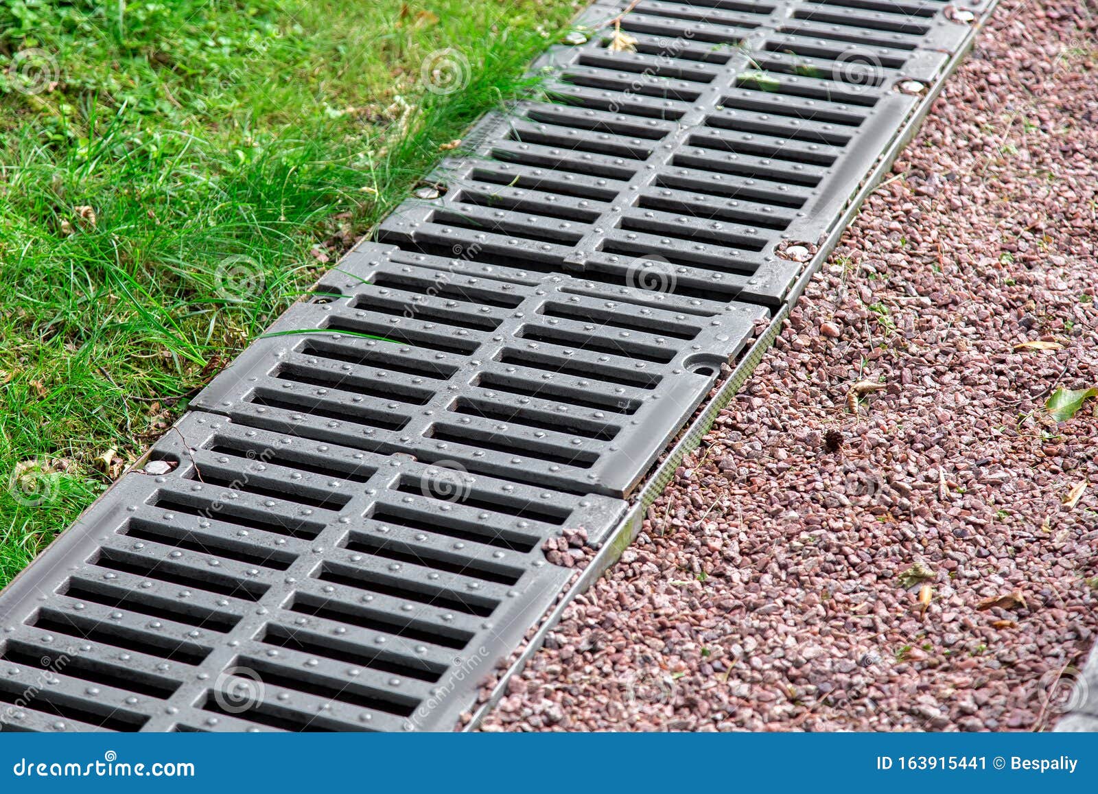 iron grate of a drainage channel on a landscape.