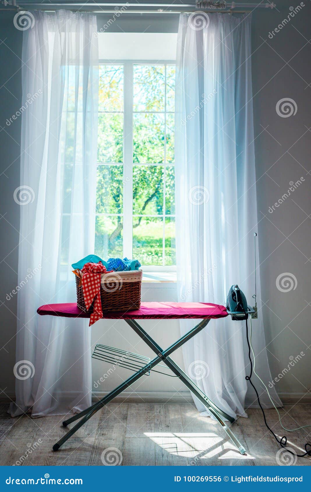 Iron and laundry in basket stock photo. Image of sunlight 100269556