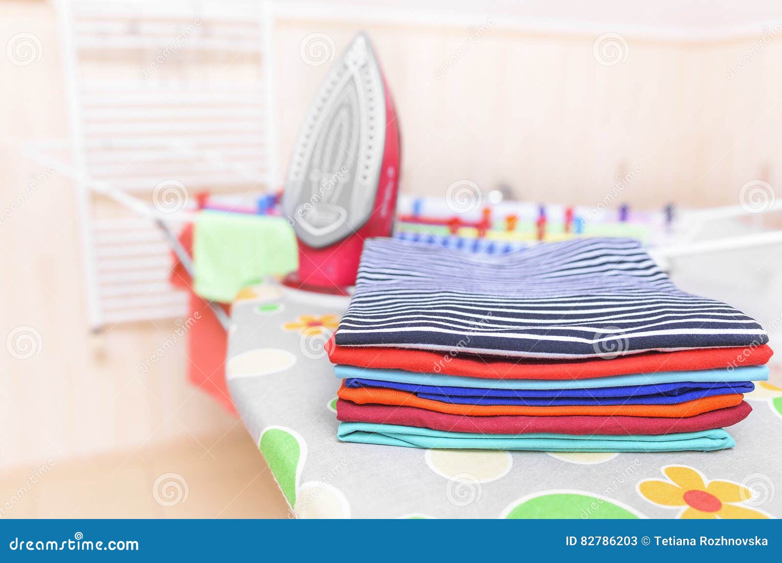 Ironed clothes on an ironing board.