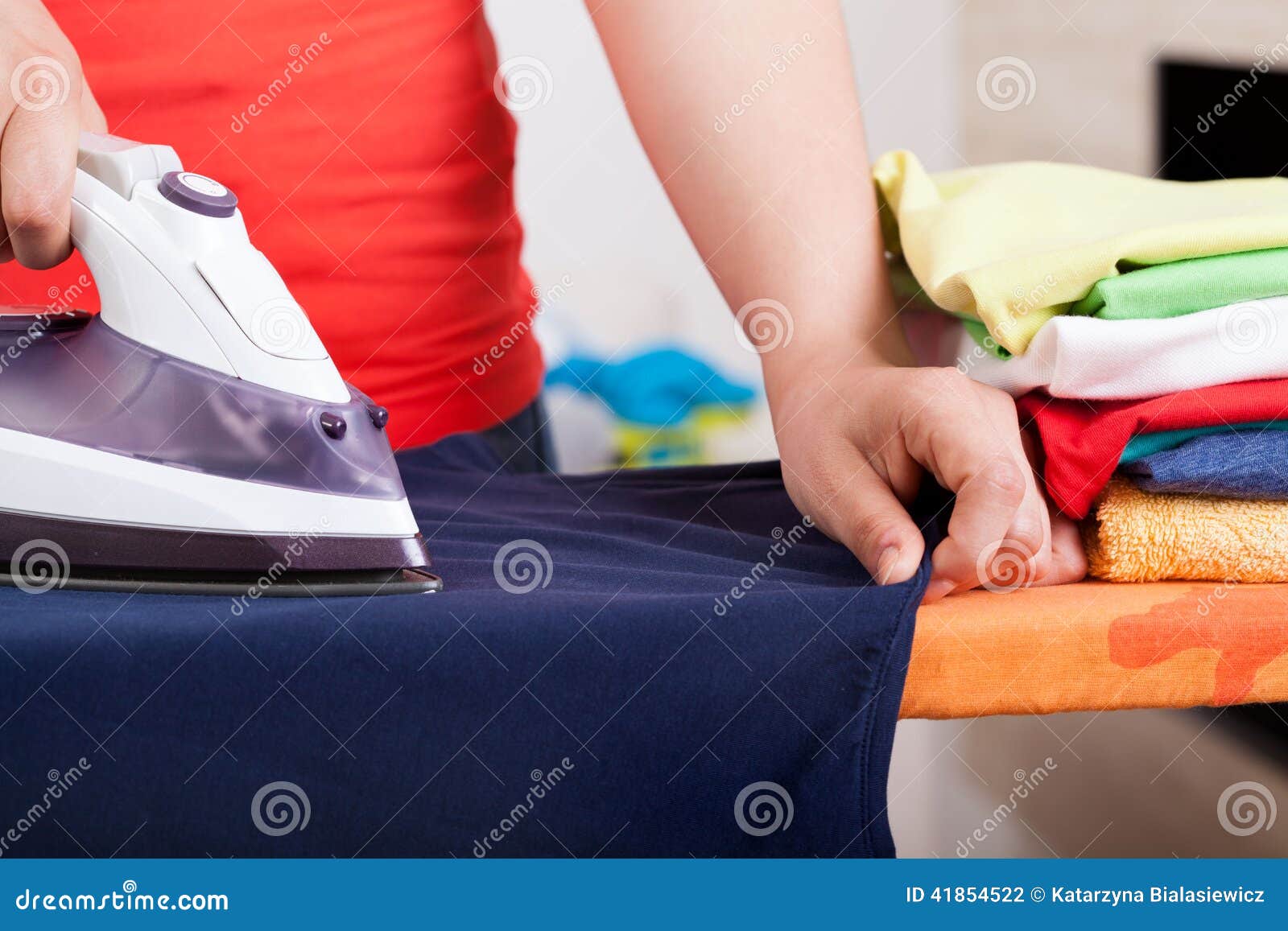 Ironing clothes and towels stock photo. Image of helper 41854522