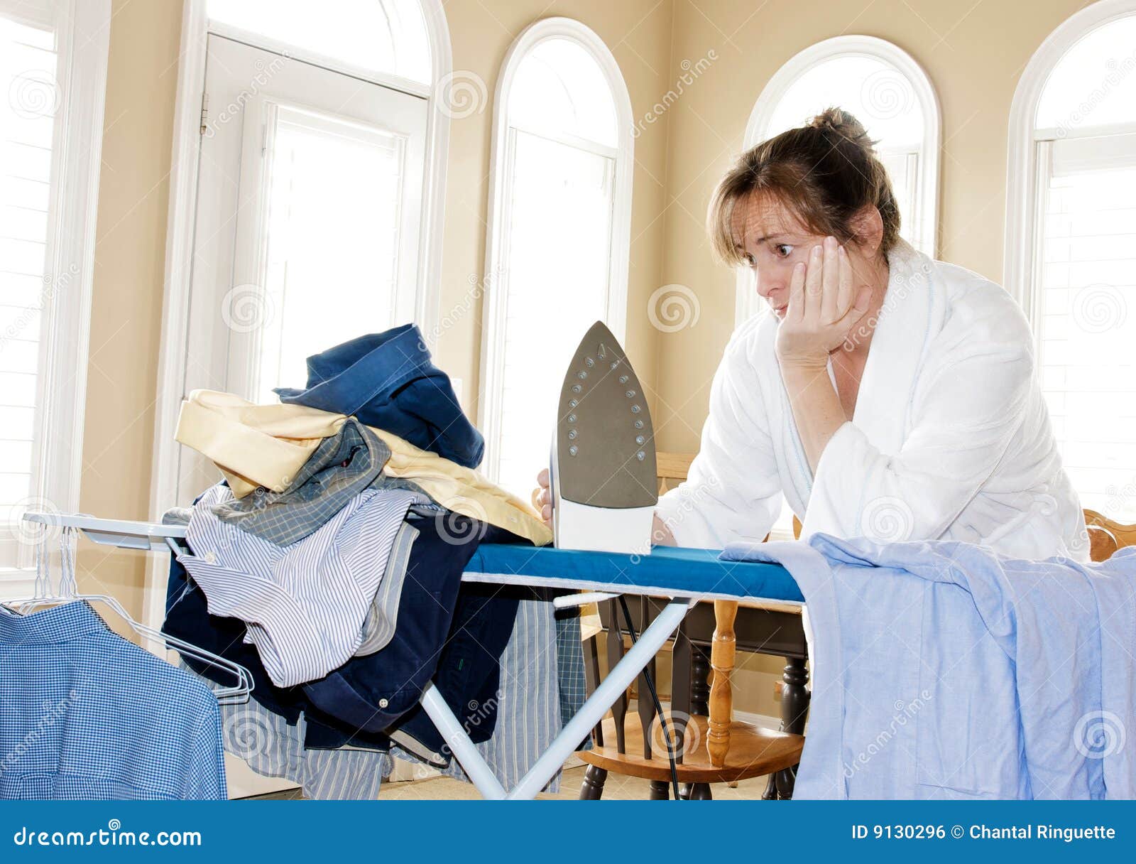 Ironing too many shirts stock photo. Image of hangers 9130296