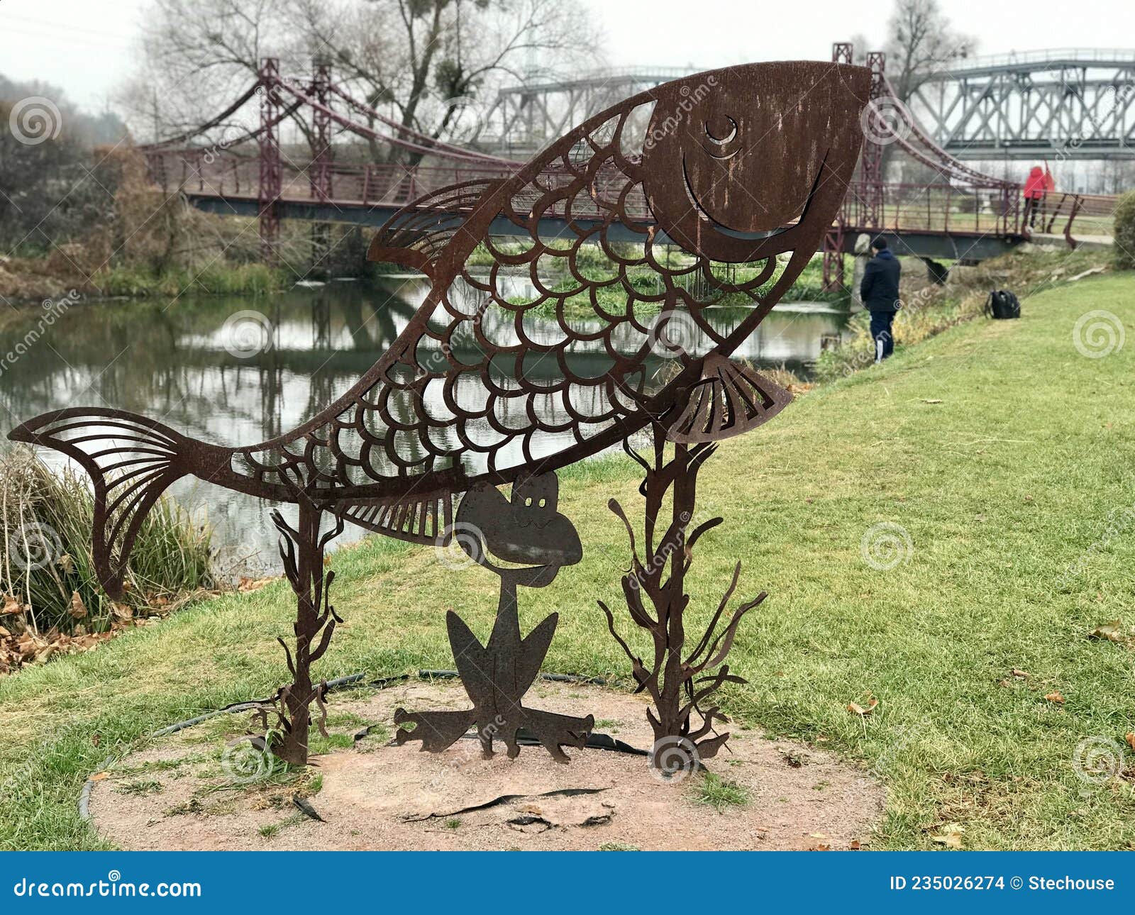 an iron fish on the boardwalk on the irpin river walk,