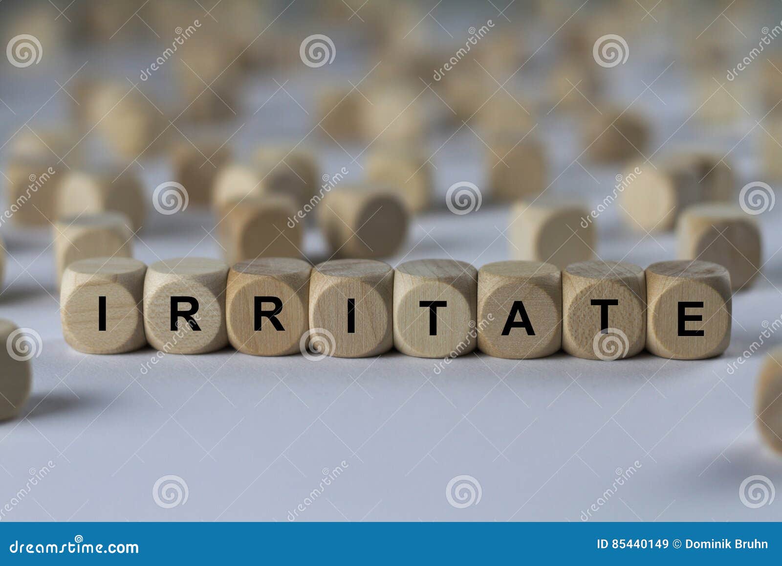 irritate - cube with letters, sign with wooden cubes