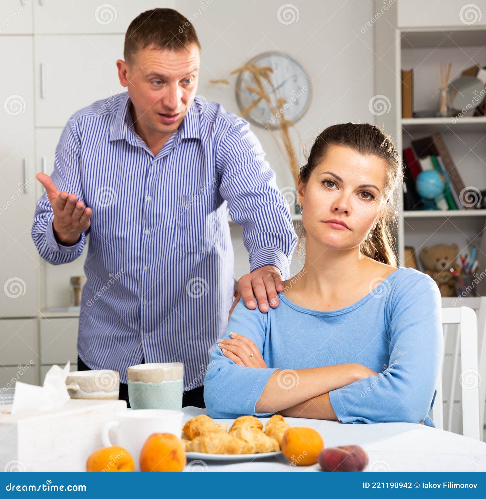 irritated young spouses quarrelling in home kitchen interior