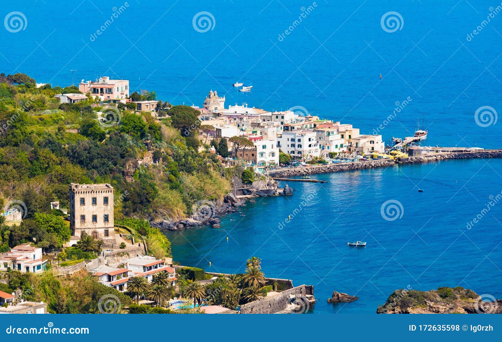 ischia ponte bordering waters of bay of cartaromana and guevara tower on ischia island, italy