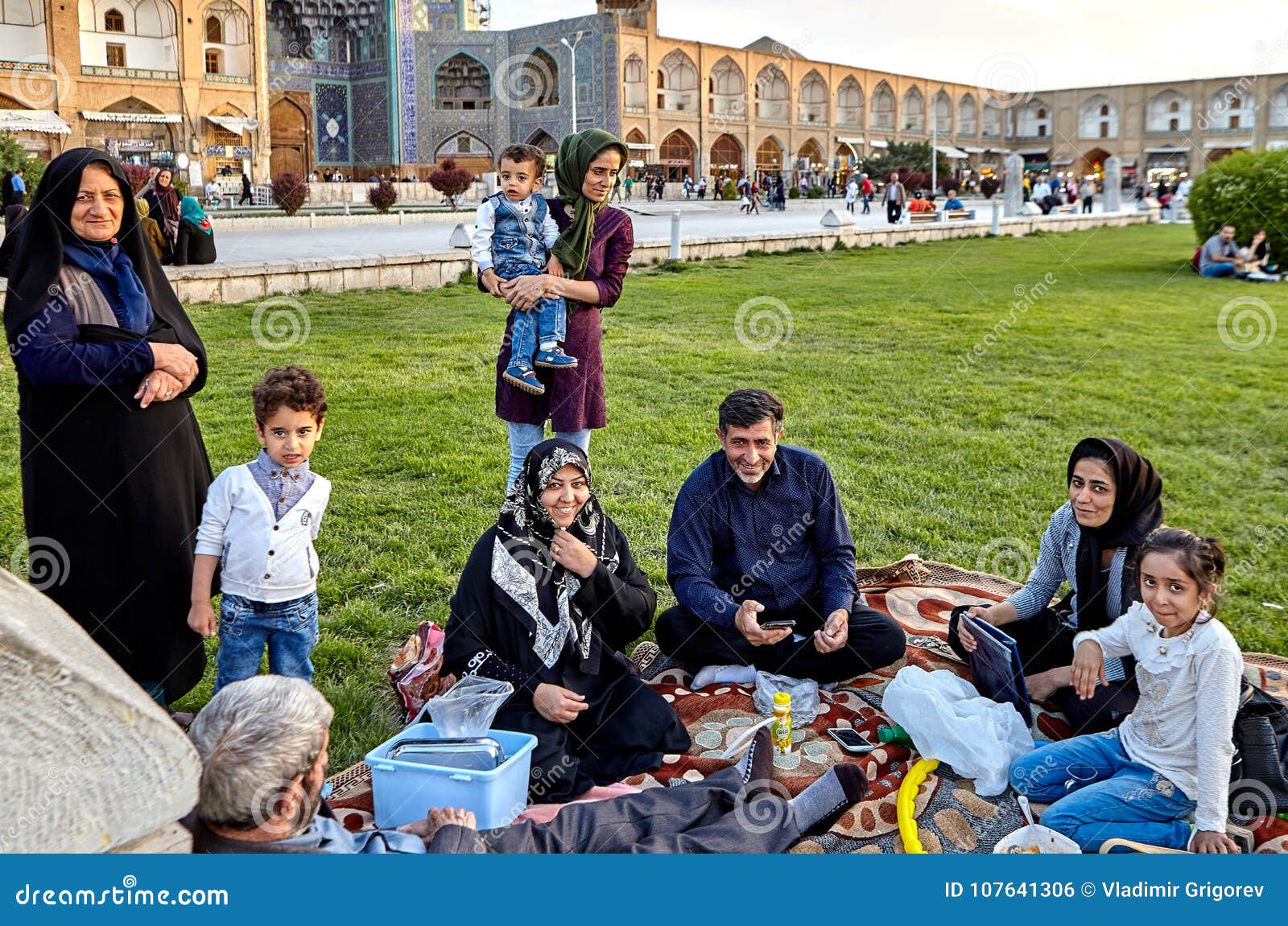 Iranian Family is Resting of Square Naghshe Jahan, Isfahan, Iran