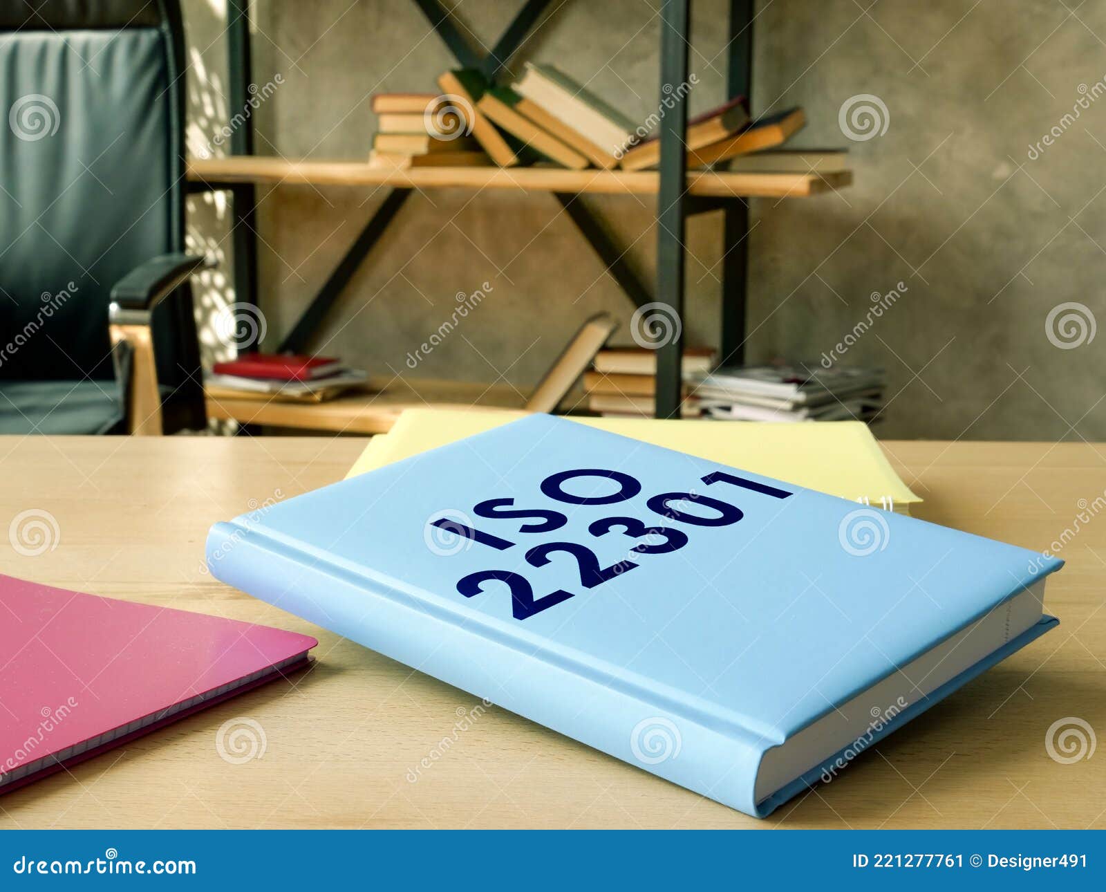 iso 22301 guide book and papers on the desk.