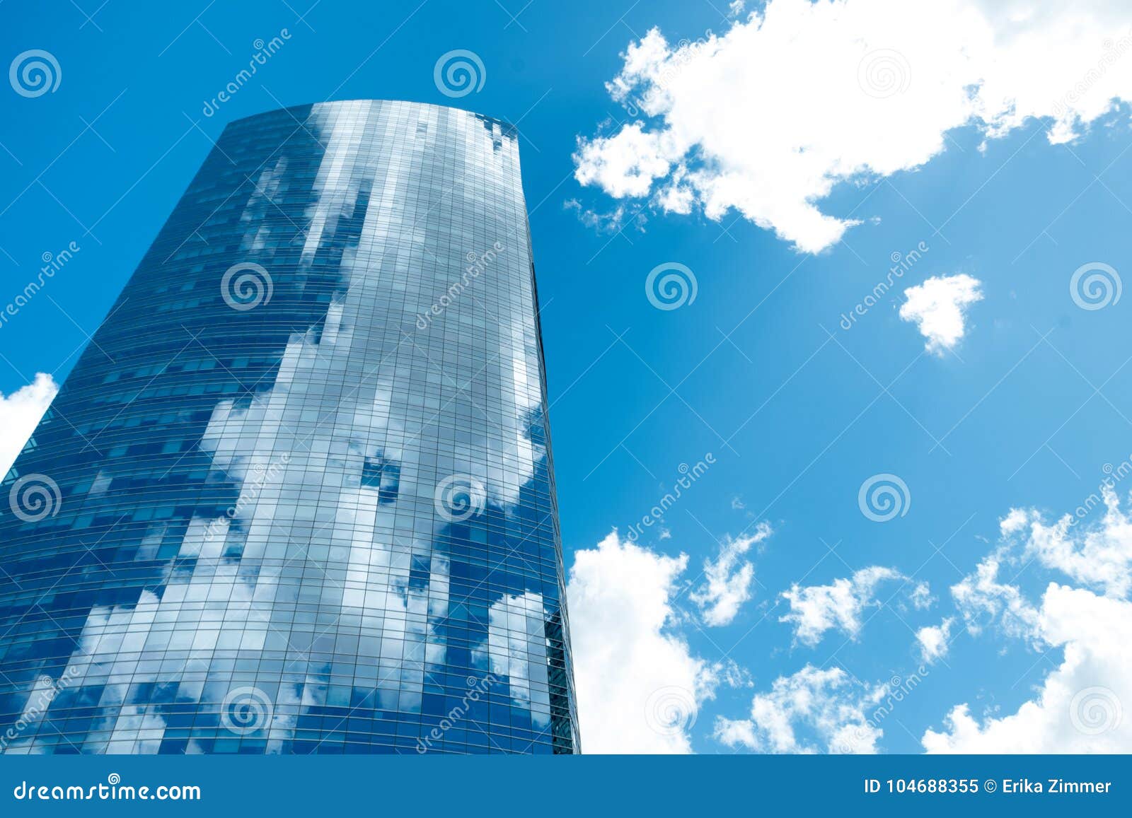  glass building in puerto madero with blue sky and reflection of clouds