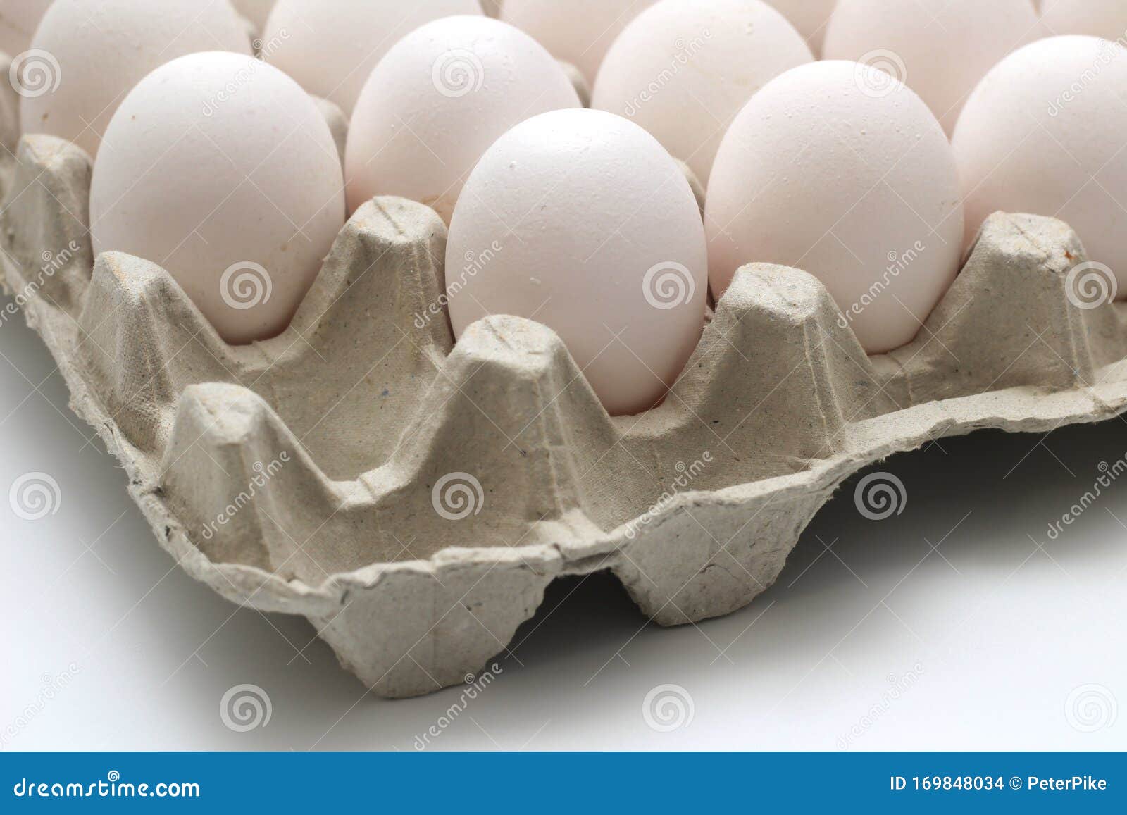  recycle tray with white eggs on a white background. tray without one egg