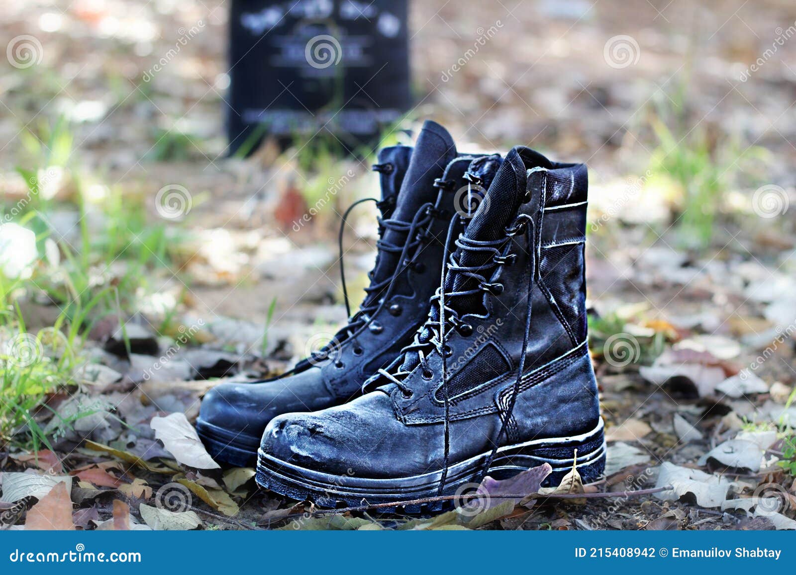 israel memorial day, yom hazikaron, concept. israeli soldier boots on the graveyard in the background a monument