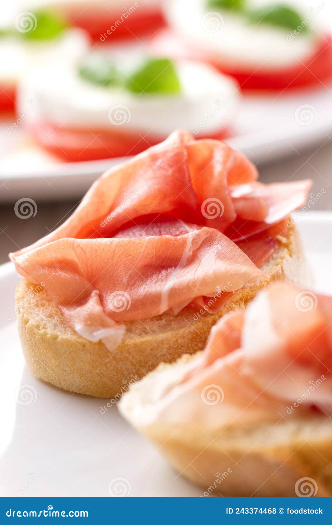 Italian Appetizer Bruschetta with Parma Ham on a Plate Stock Photo
