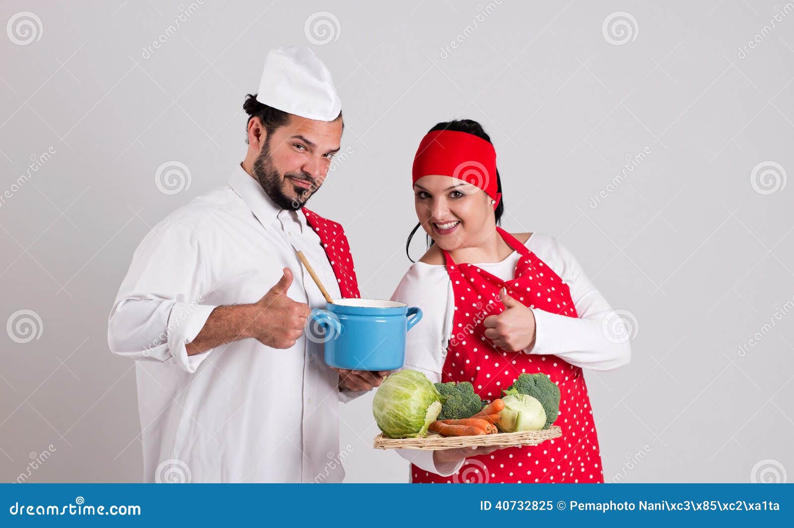 italian chief cook in red apron and handsome cook are showing nu