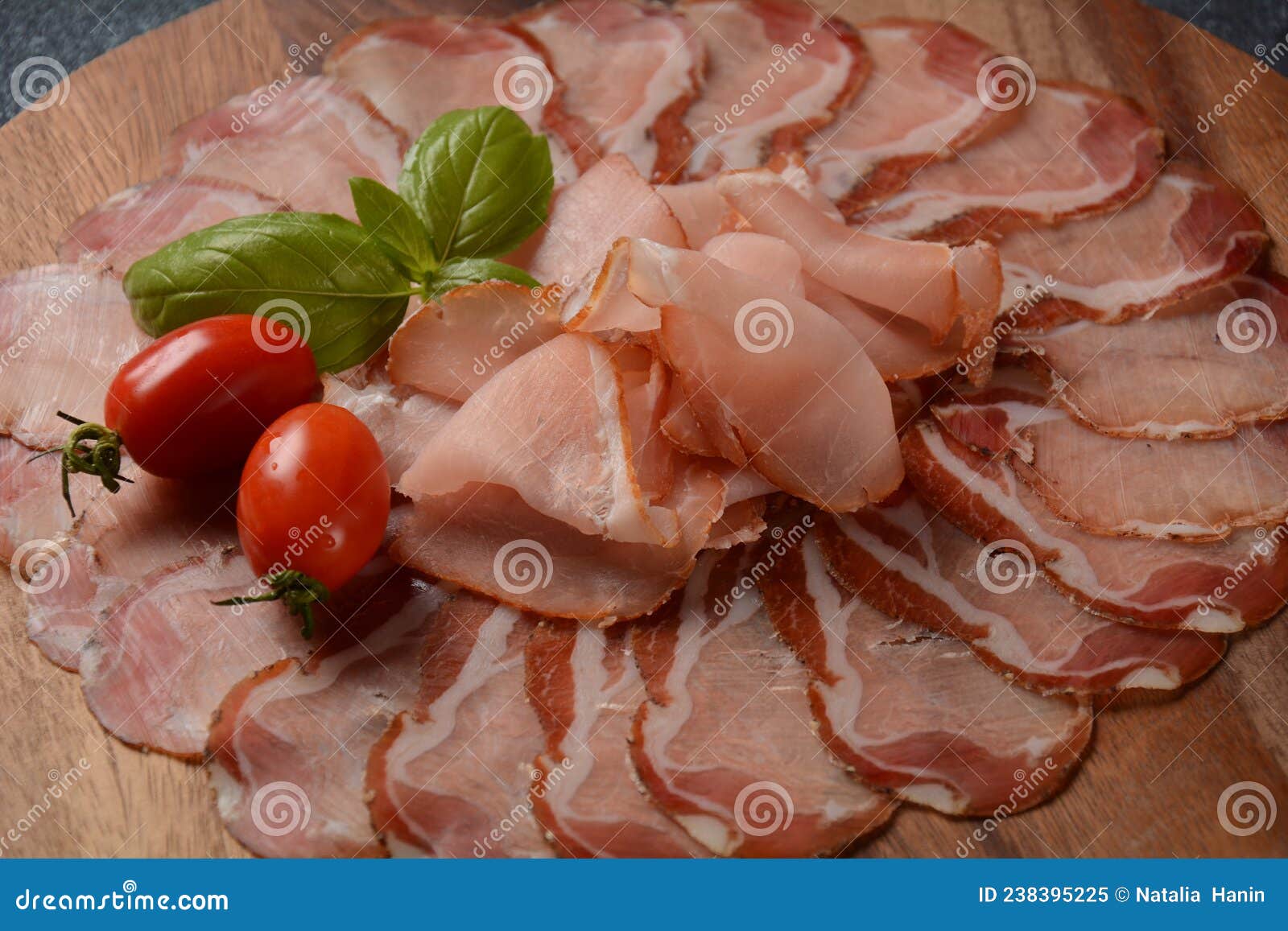italian cured pork shoulder. antipasto platter coppa stagionata and cherry tomatoes.