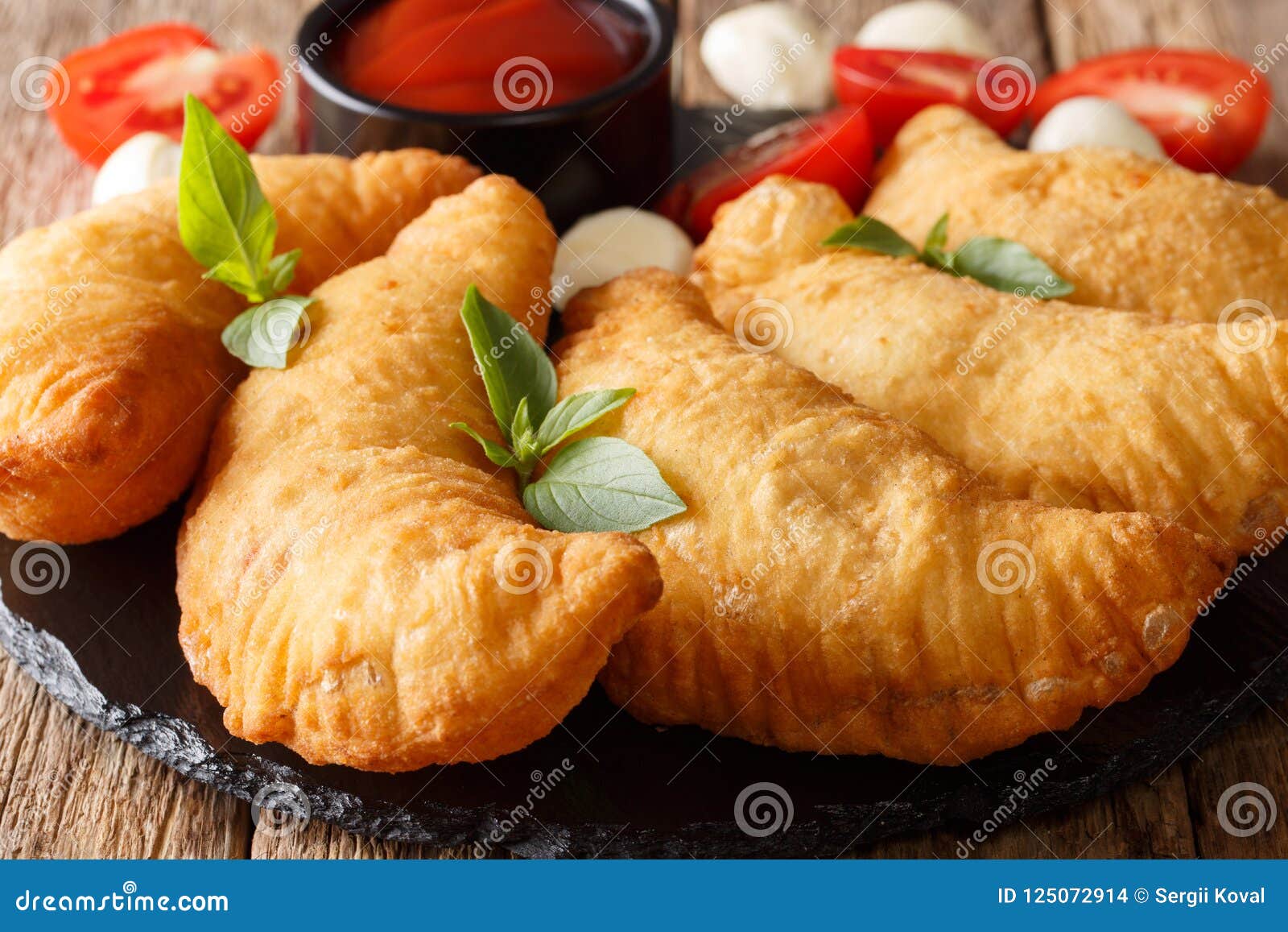 Italian Fast Food: Fried Panzerotti with Tomato Sauce, Herbs and Stock ...