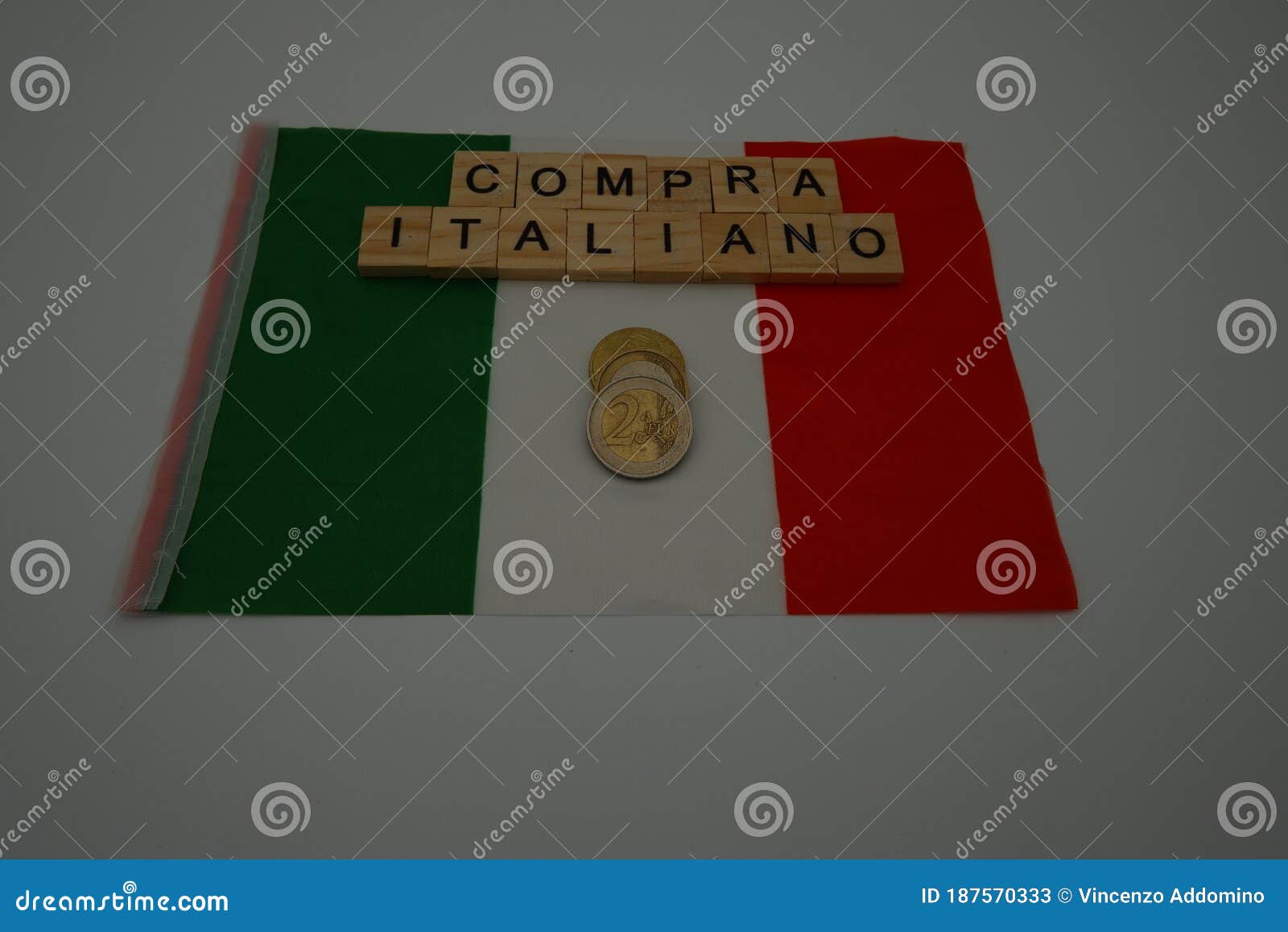 an italian flag with written,  compra italiano which in english means, buy italian and with some coins