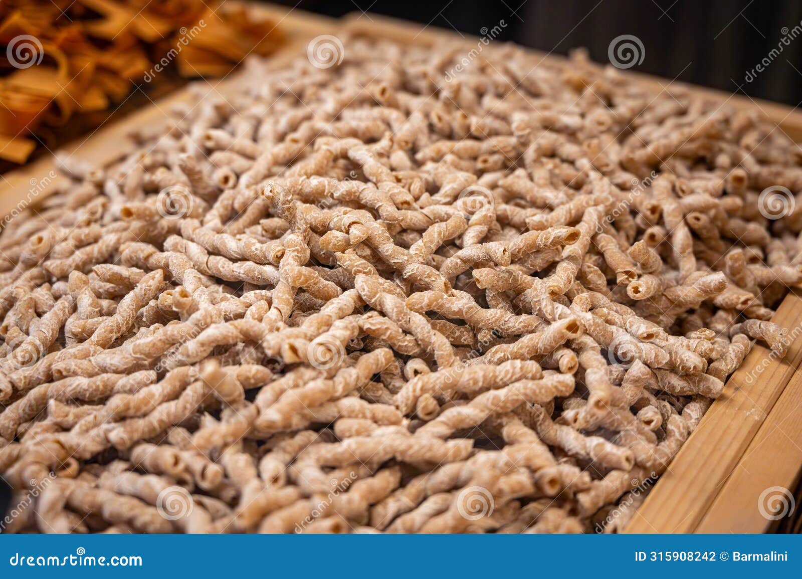 italian food, dried handmade colorful pasta with walnuts, ready to cook, milan, lombardy, italy