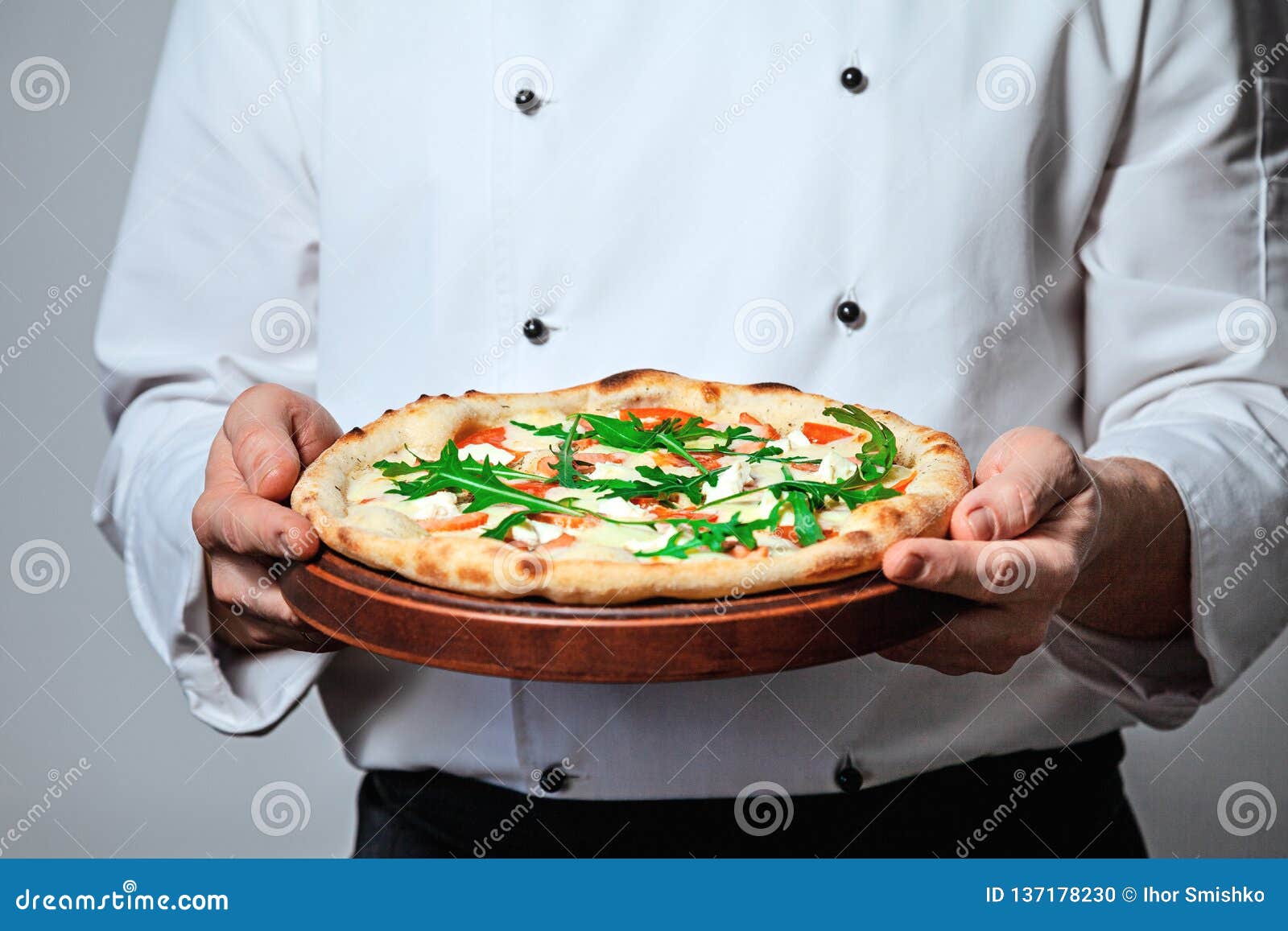 Italian Man Chef Cook Holding a Finished Pizza on a Gray Background ...