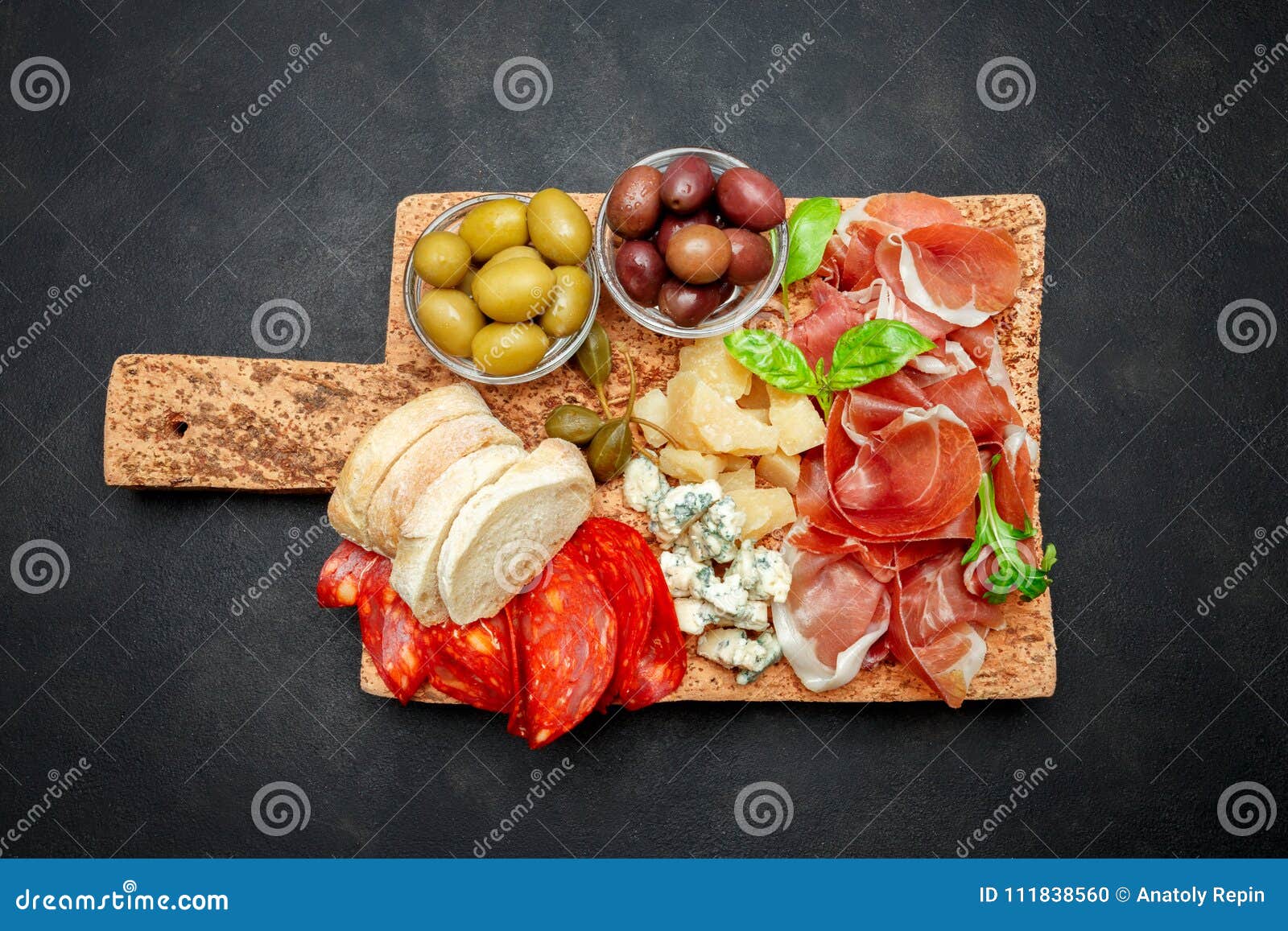 italian prosciutto crudo or spanish jamon, cheese, olives and bread